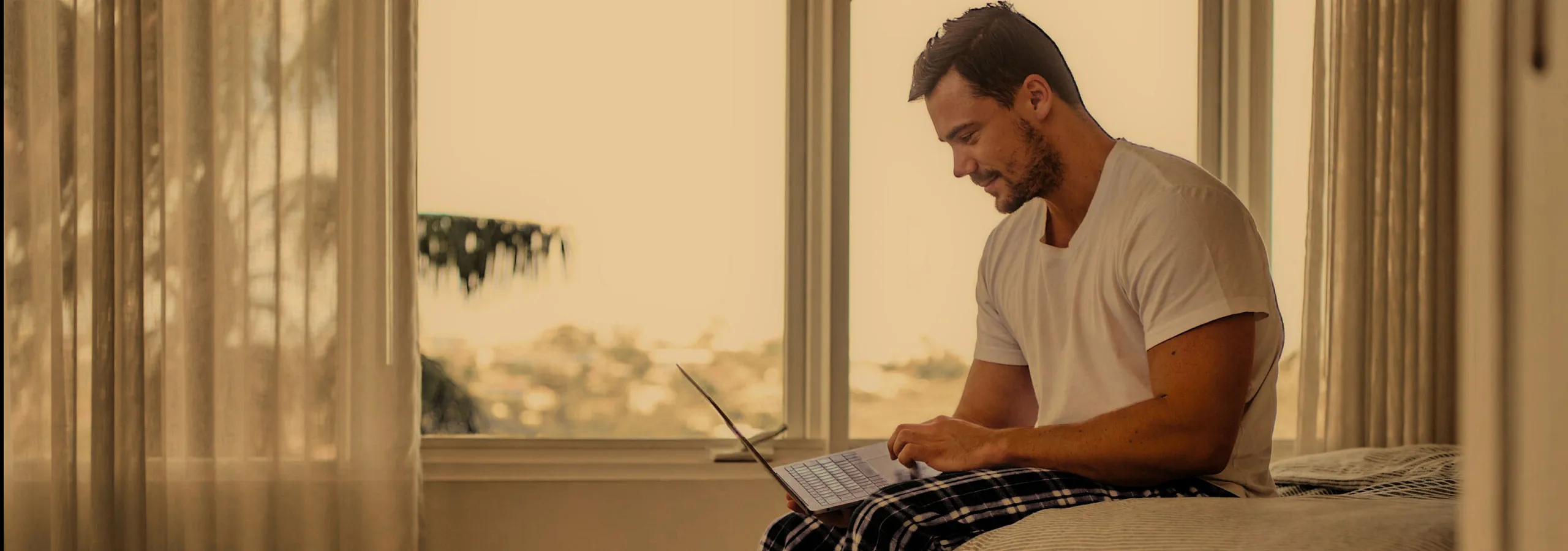 man using laptop in apartment