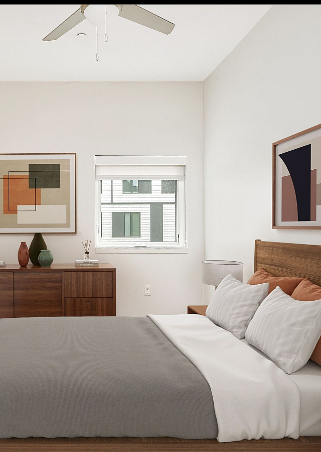Virtually staged baedroom at Lyra with a bed, dresser, lamp, art