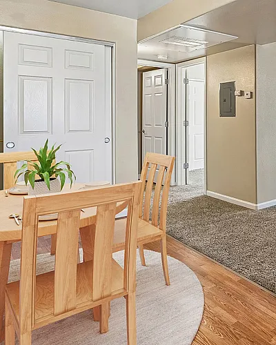 virtually staged kitchen with fridge, coffee maker, and table and chairs.