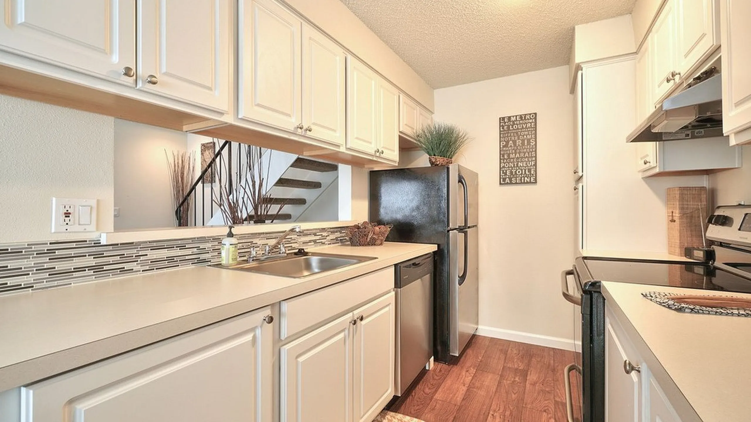 Long kitchen counter layout equipped with updated major appliances at CAMPBELL PARK.
