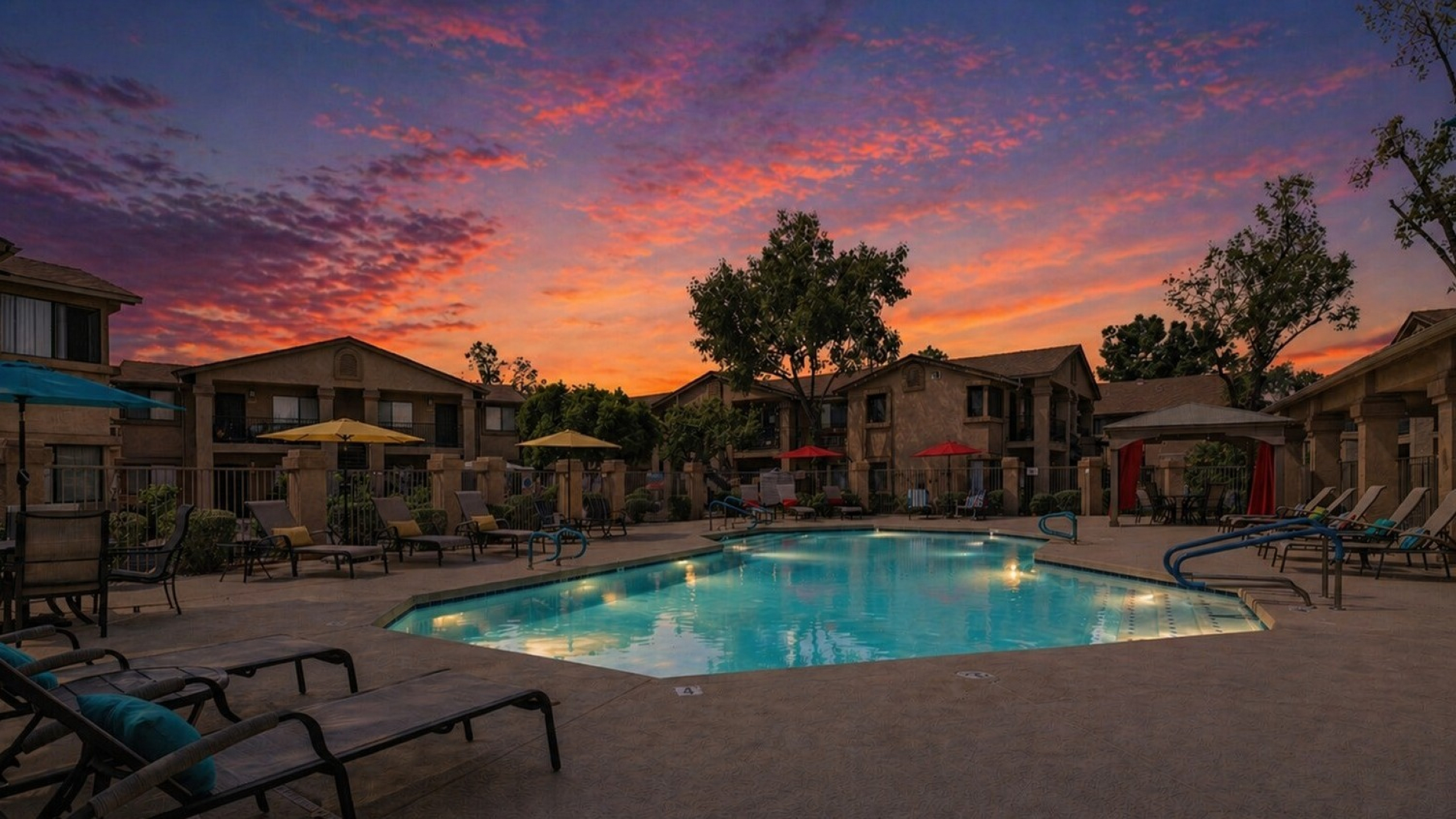 pool with lounge chairs and cabana at dusk at orchard mesa