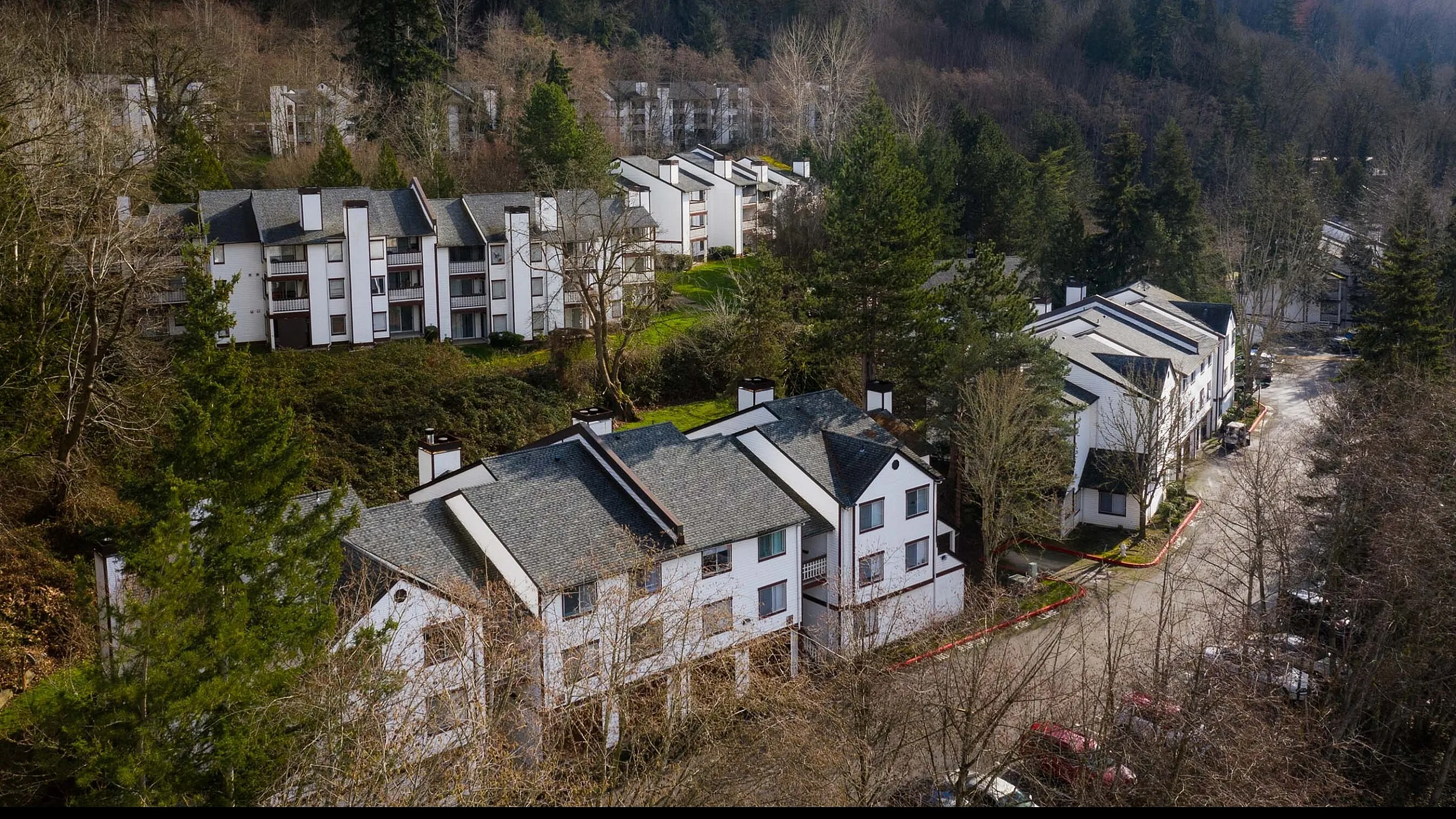 Aerial drone view of multi-level buildings on a hillside at Berkeley Heights Apartment Homes.