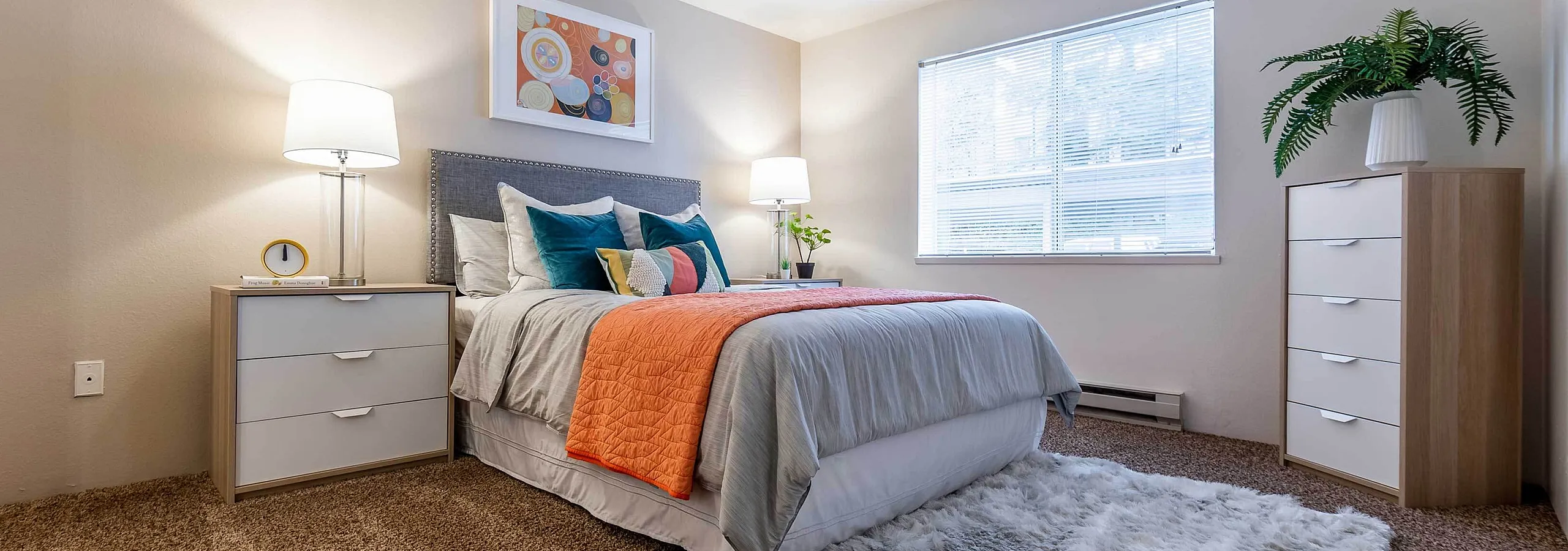 Modern bedroom styling showcasing a colorful accent blanket at Berkeley Heights Apartment Homes.
