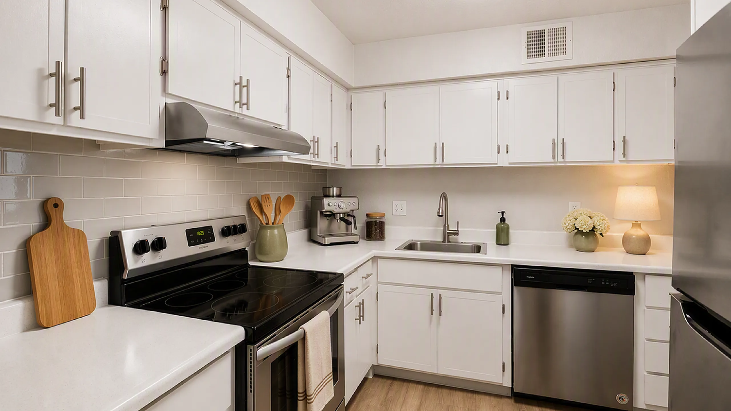 kitchen with stainless steel appliances, ceramic subway tile backsplash and faux hardwood flooring at peoria grand apartments