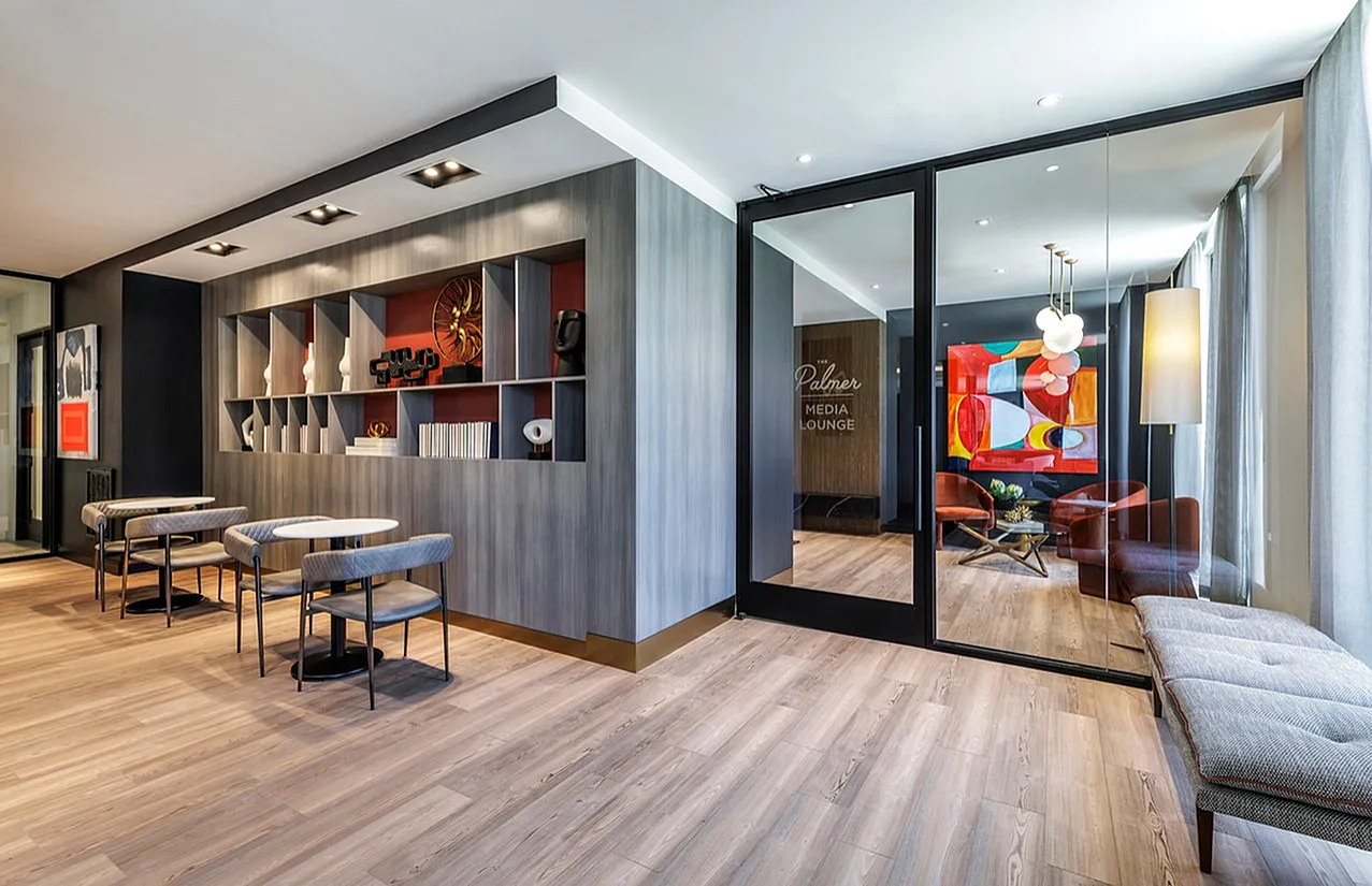 Elegant lounge area with modern decor, stylish seating, and vibrant artwork.