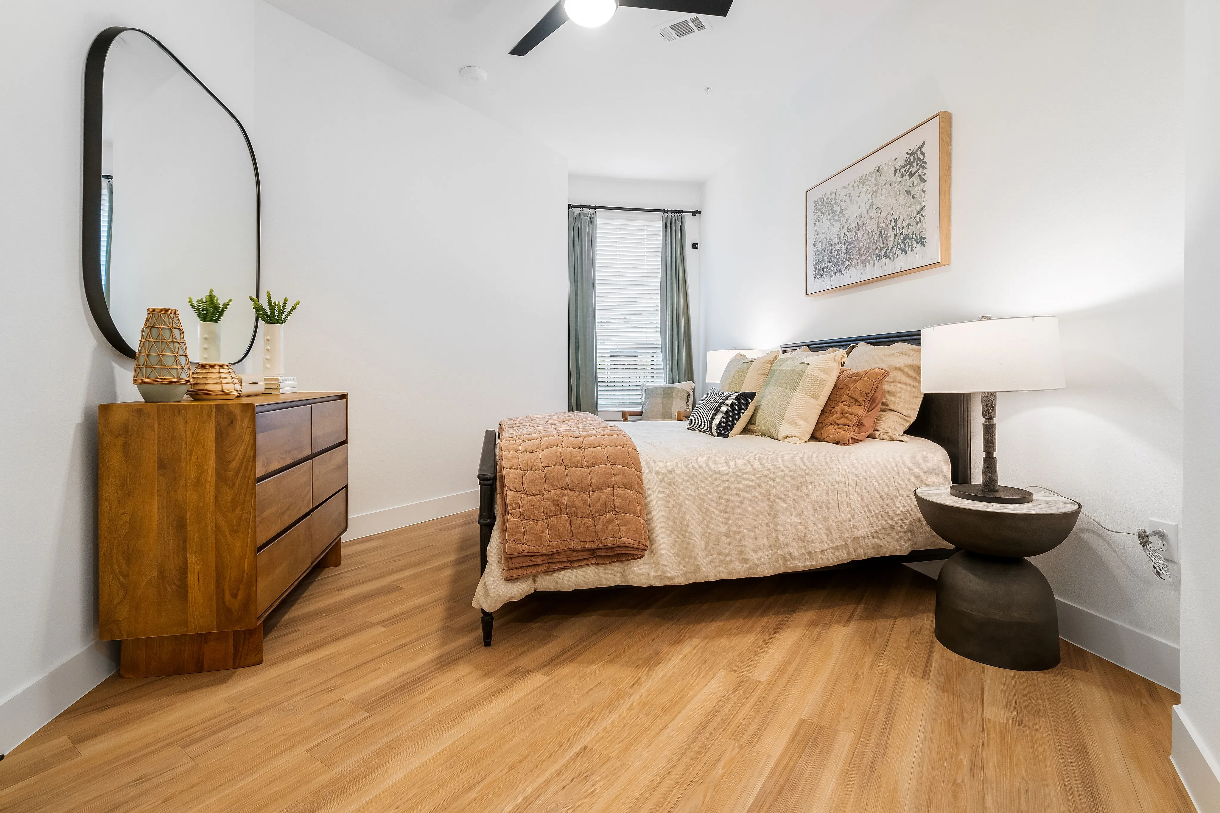 houston apartments | apartments near memorial city | apartments zoned to Katy ISD | apartments near hwy6 |Inviting bedroom with modern decor, featuring a cozy bed with plush pillows, elegant wooden dresser, and stylish lighting for a serene ambiance.