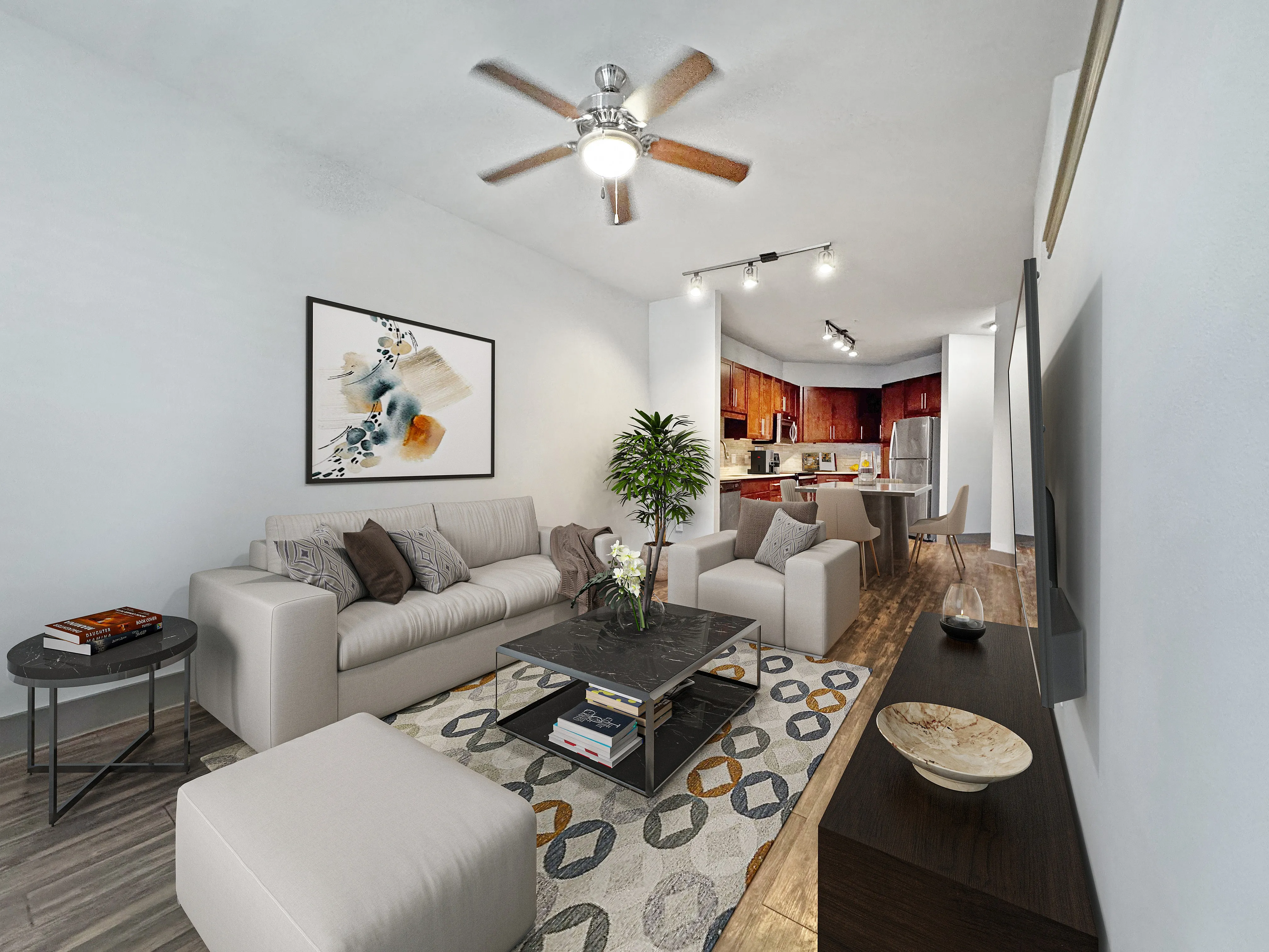 Bright and welcoming open-concept living room with elegant decor, a modern ceiling fan, and a stylish kitchen in the background.