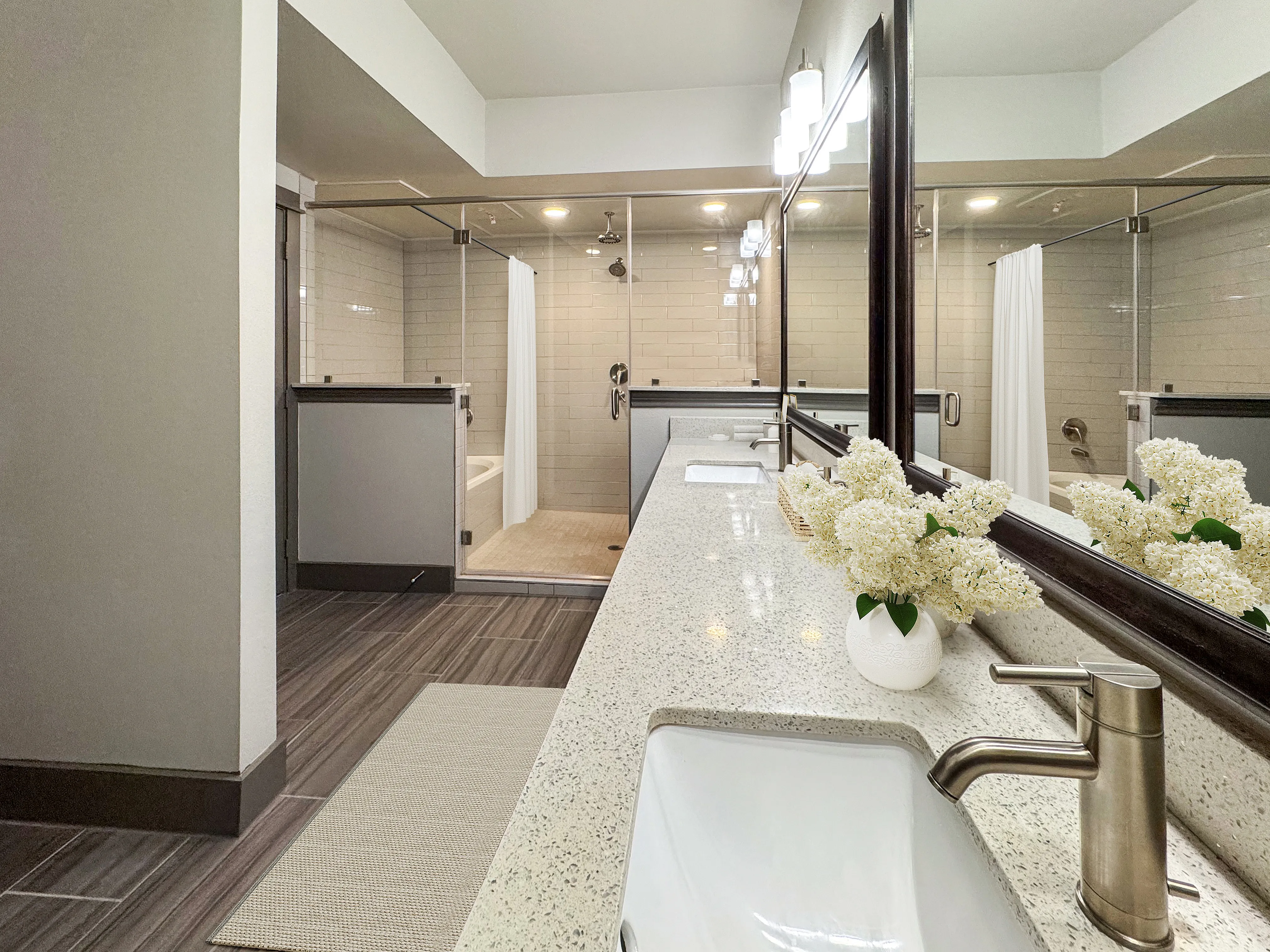Luxurious bathroom with a sleek double vanity, modern fixtures, and a spacious walk-in shower, creating a spa-like retreat.