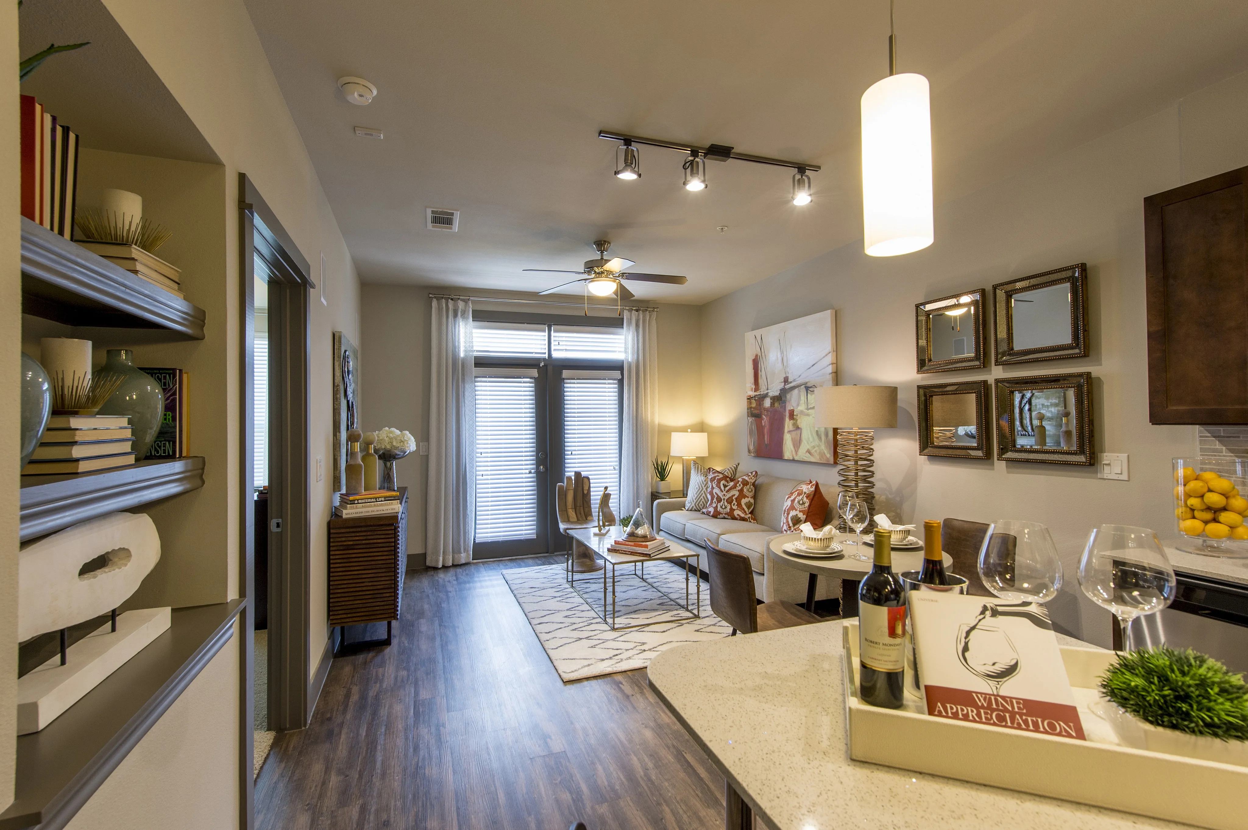 Chic apartment living area featuring a modern open concept with stylish decor, cozy seating, and elegant lighting.