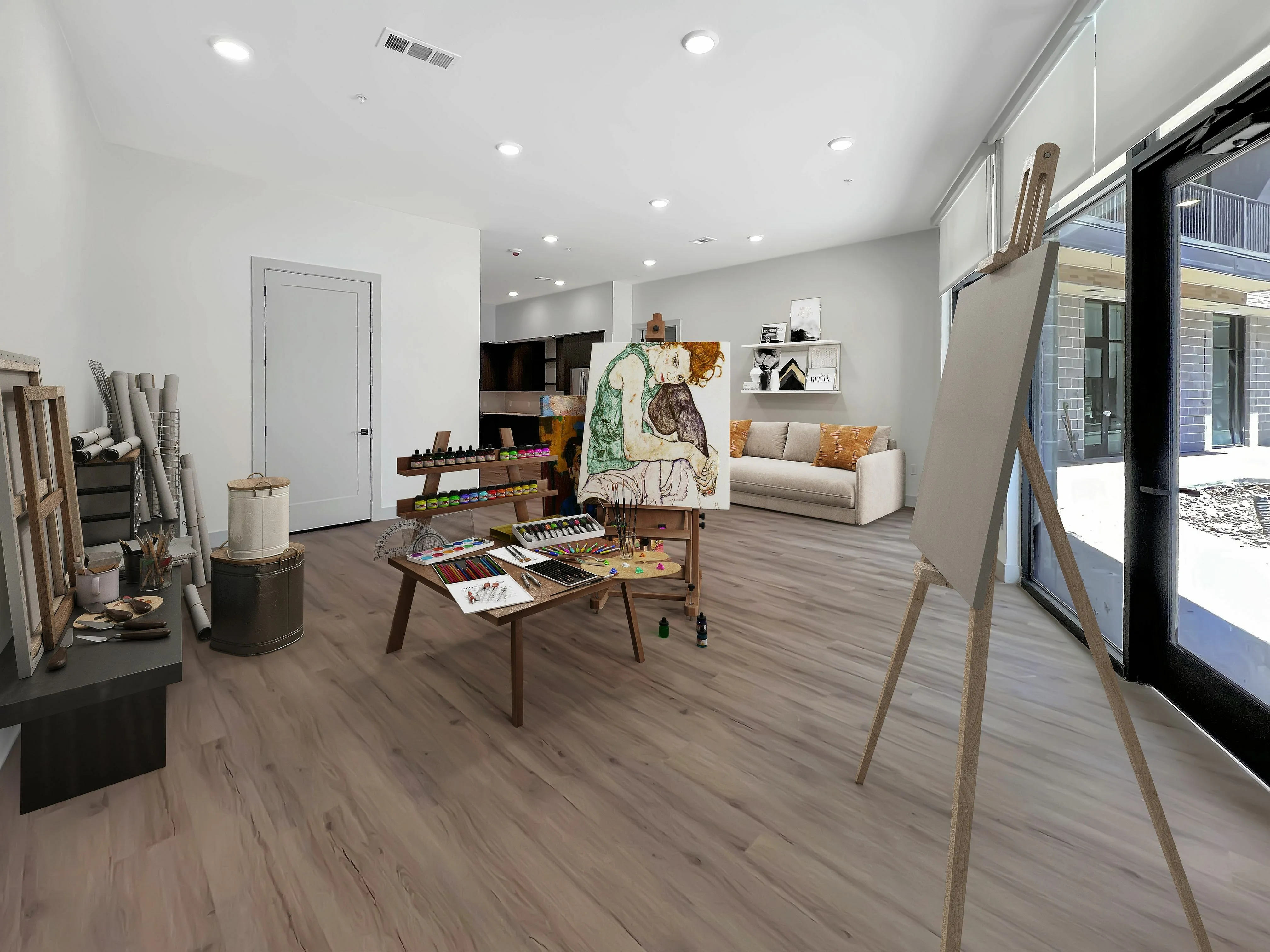 East Austin Apartments | Apartments in Austin | New apartments in Austin |Bright and inviting art studio space with wooden floors, natural light, and painting supplies scattered across the table, perfect for creative inspiration.