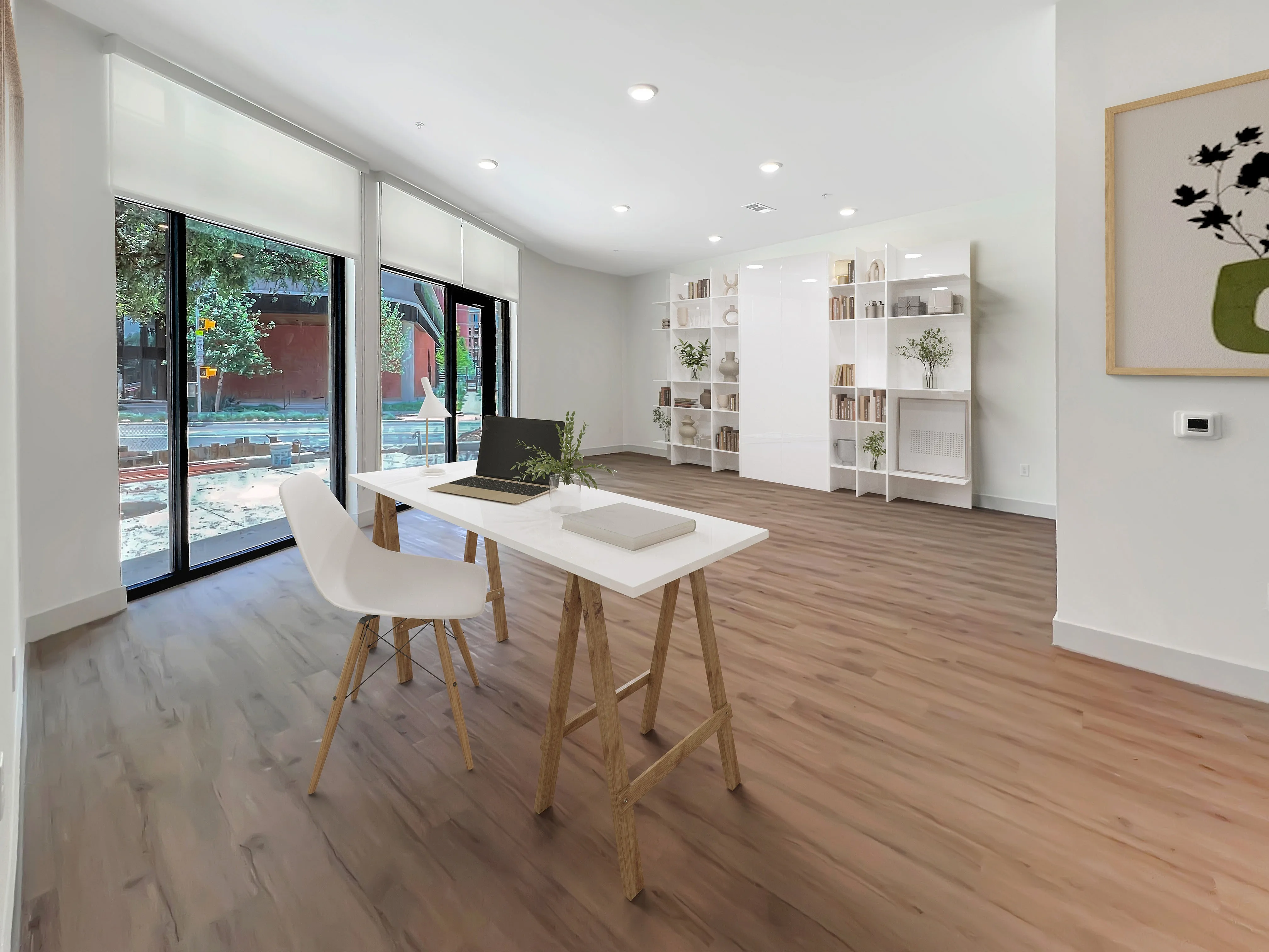East Austin Apartments | Apartments in Austin | New apartments in Austin |Bright, modern home office with sleek white desk, stylish shelving, and floor-to-ceiling windows offering a serene view.