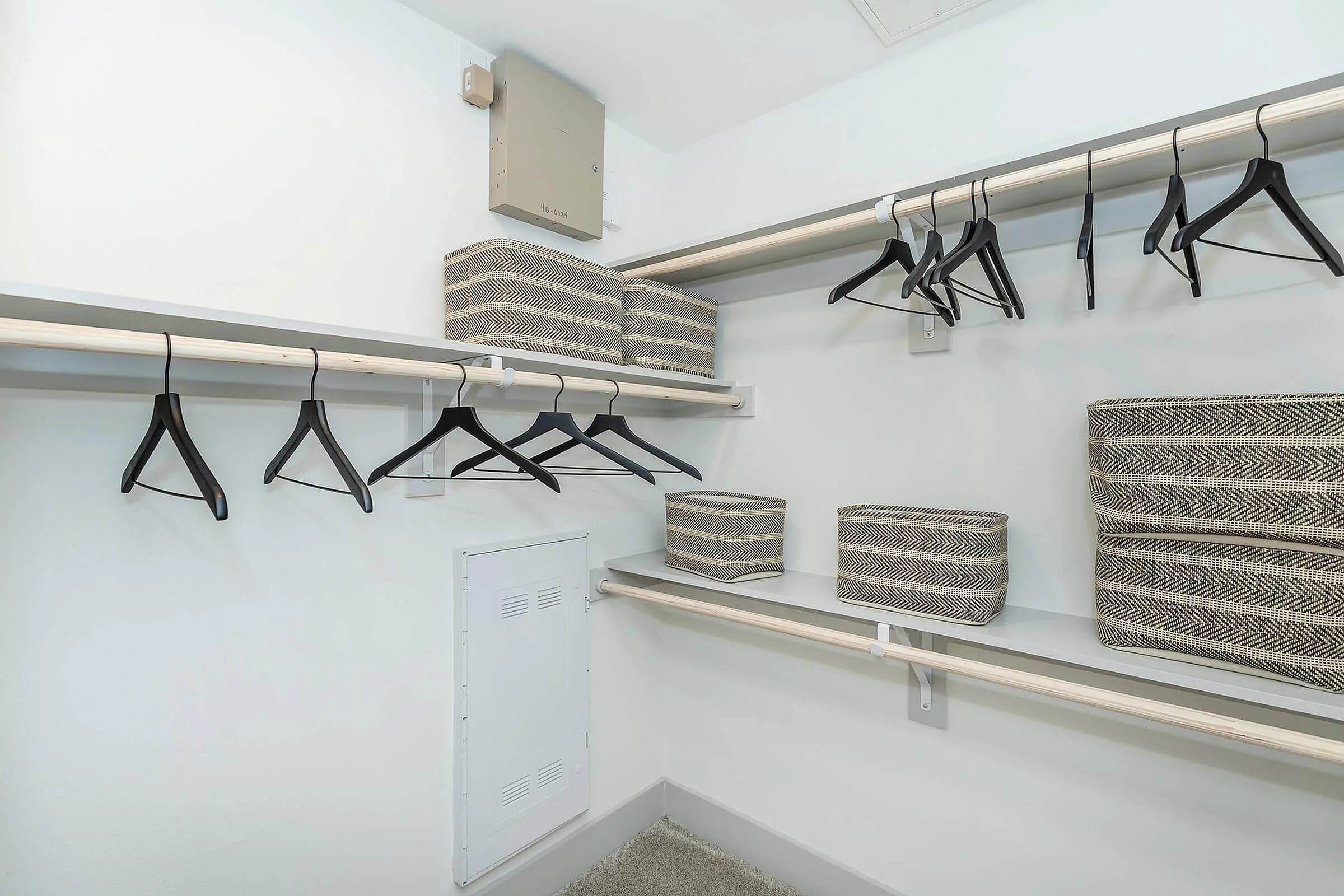 Spacious walk-in closet with modern shelving, ample hanging space, and stylish storage bins.