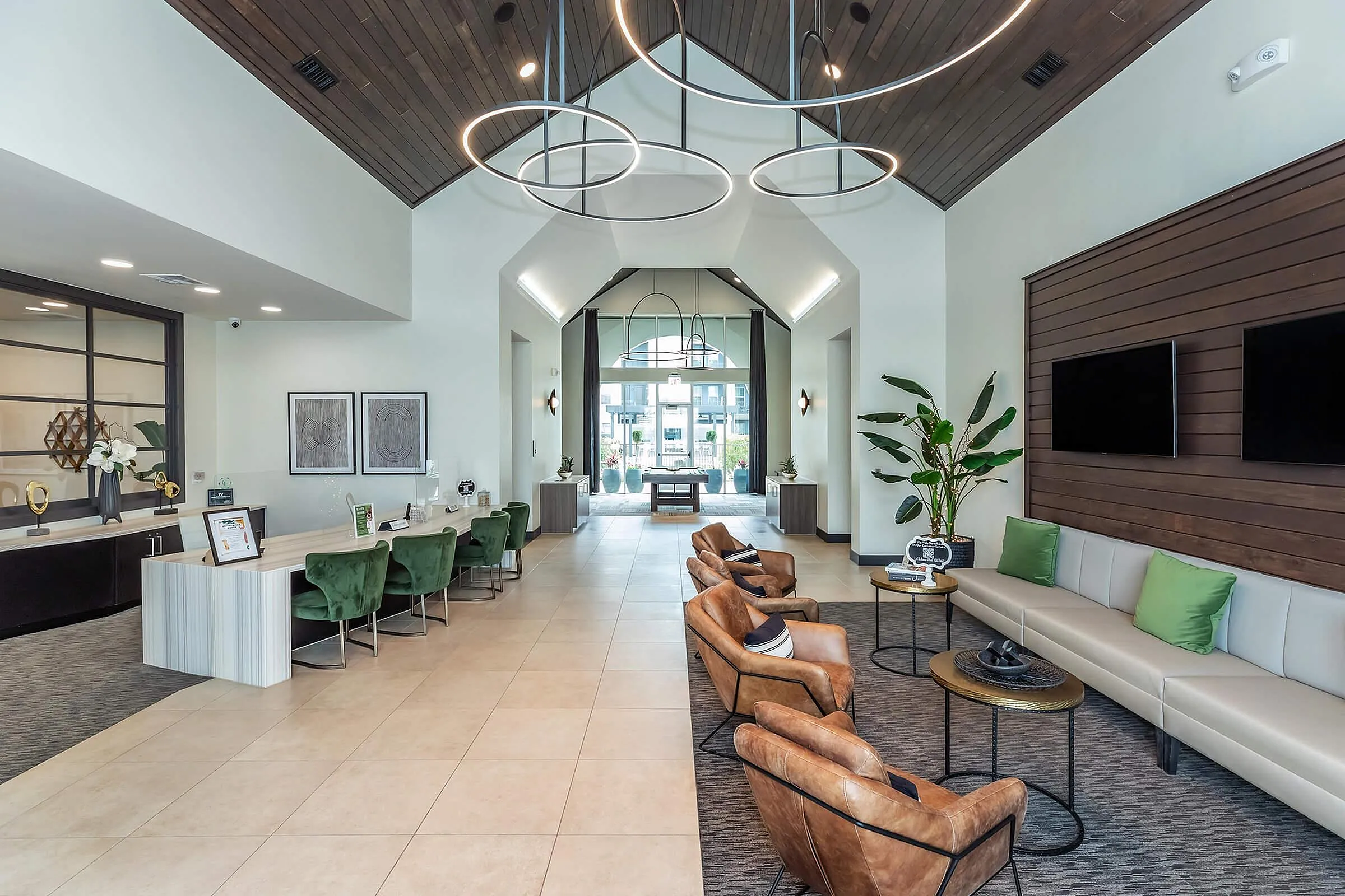 Luxurious apartment lobby with contemporary design, featuring elegant seating, modern lighting fixtures, and stylish decor.