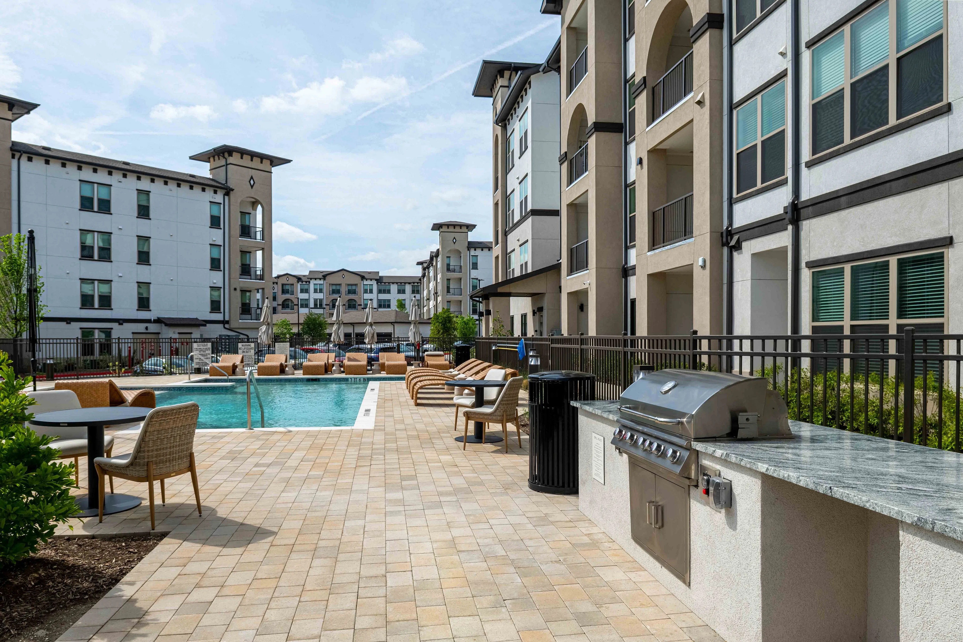 Caroline Florence | Apartments in McKinney Texas | Resort‑style swimming pool with lounge seating at Caroline Florence