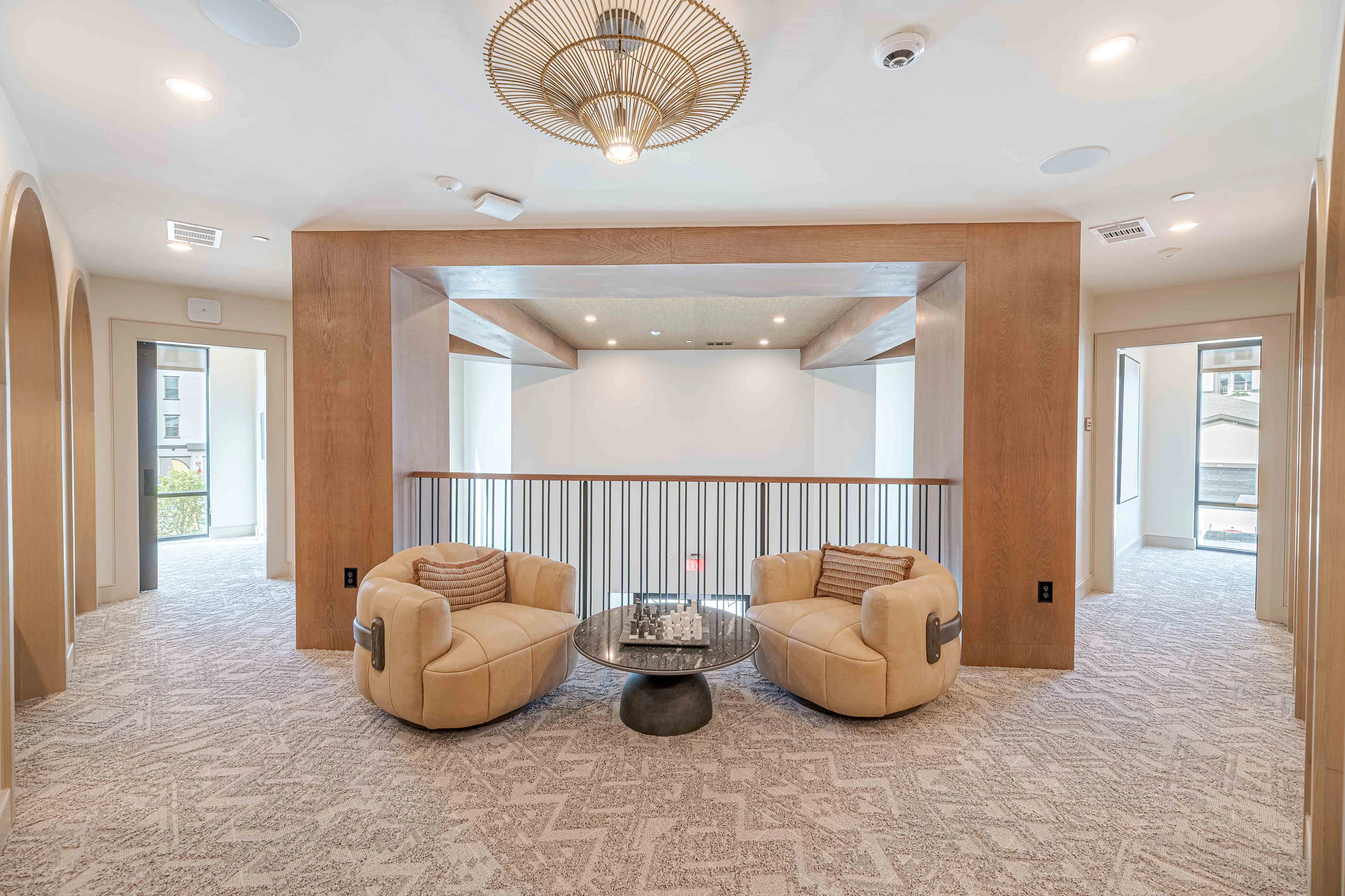 Luxurious apartment interior featuring cozy armchairs, elegant decor, and spacious design.