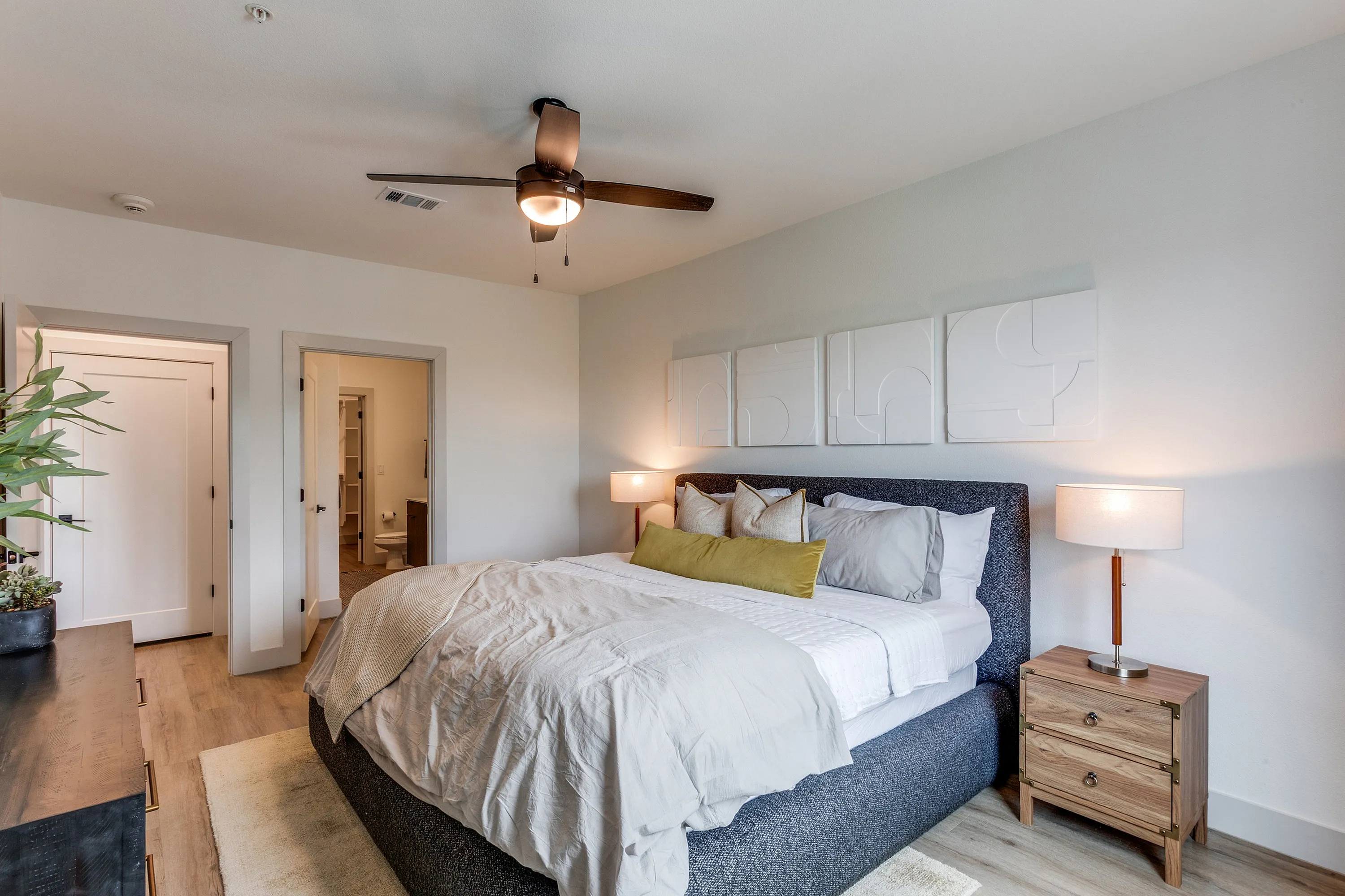 Inviting bedroom with elegant decor, featuring a king-sized bed, plush pillows, and serene lighting for a cozy and modern atmosphere.