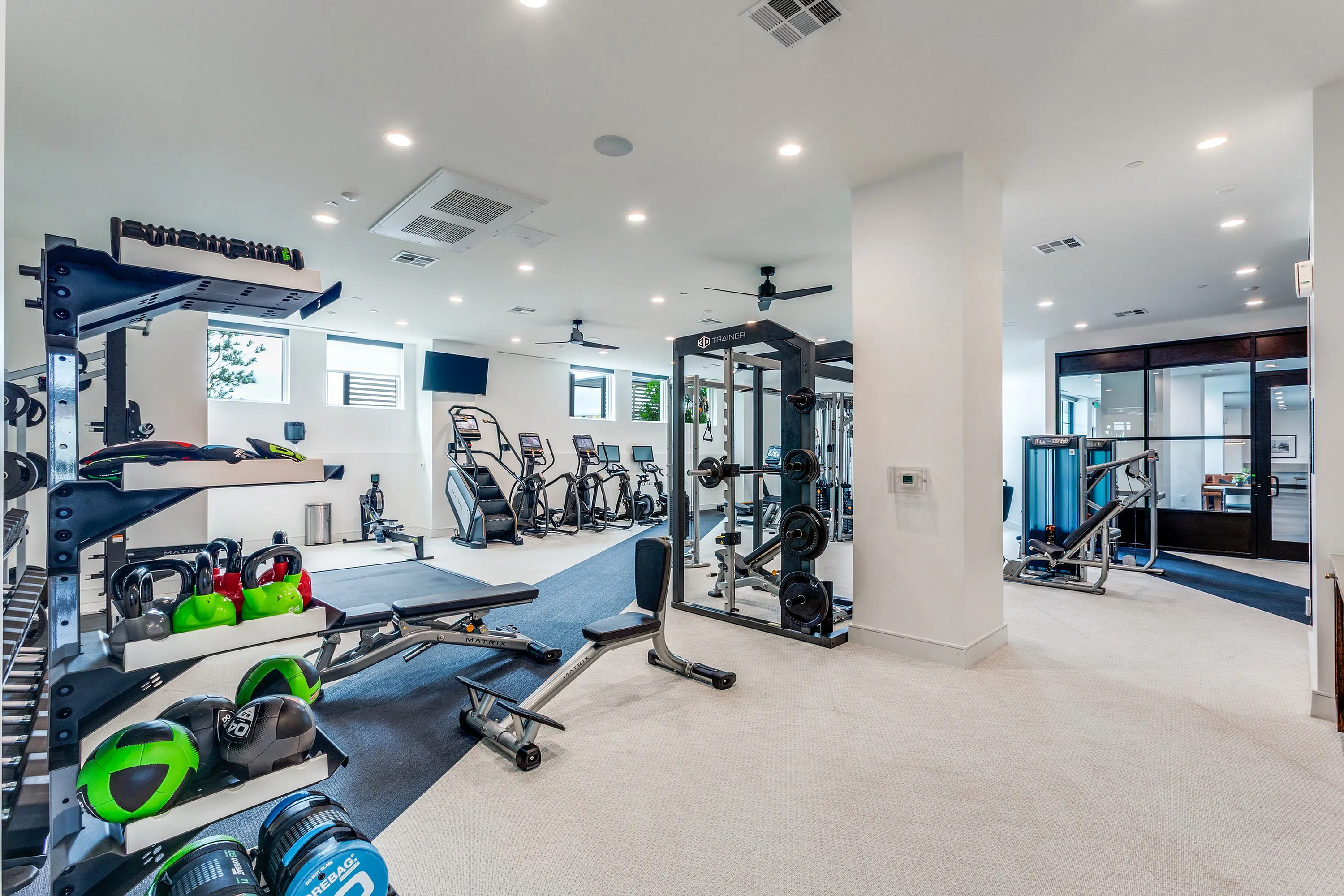 Modern fitness center featuring state-of-the-art equipment, ample space, and stylish design for an invigorating workout experience.