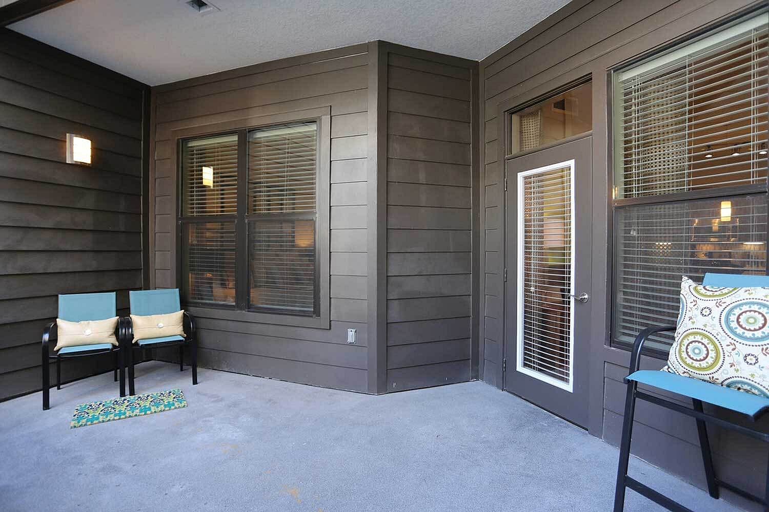 Charming apartment balcony with cozy seating and modern design perfect for relaxation.
