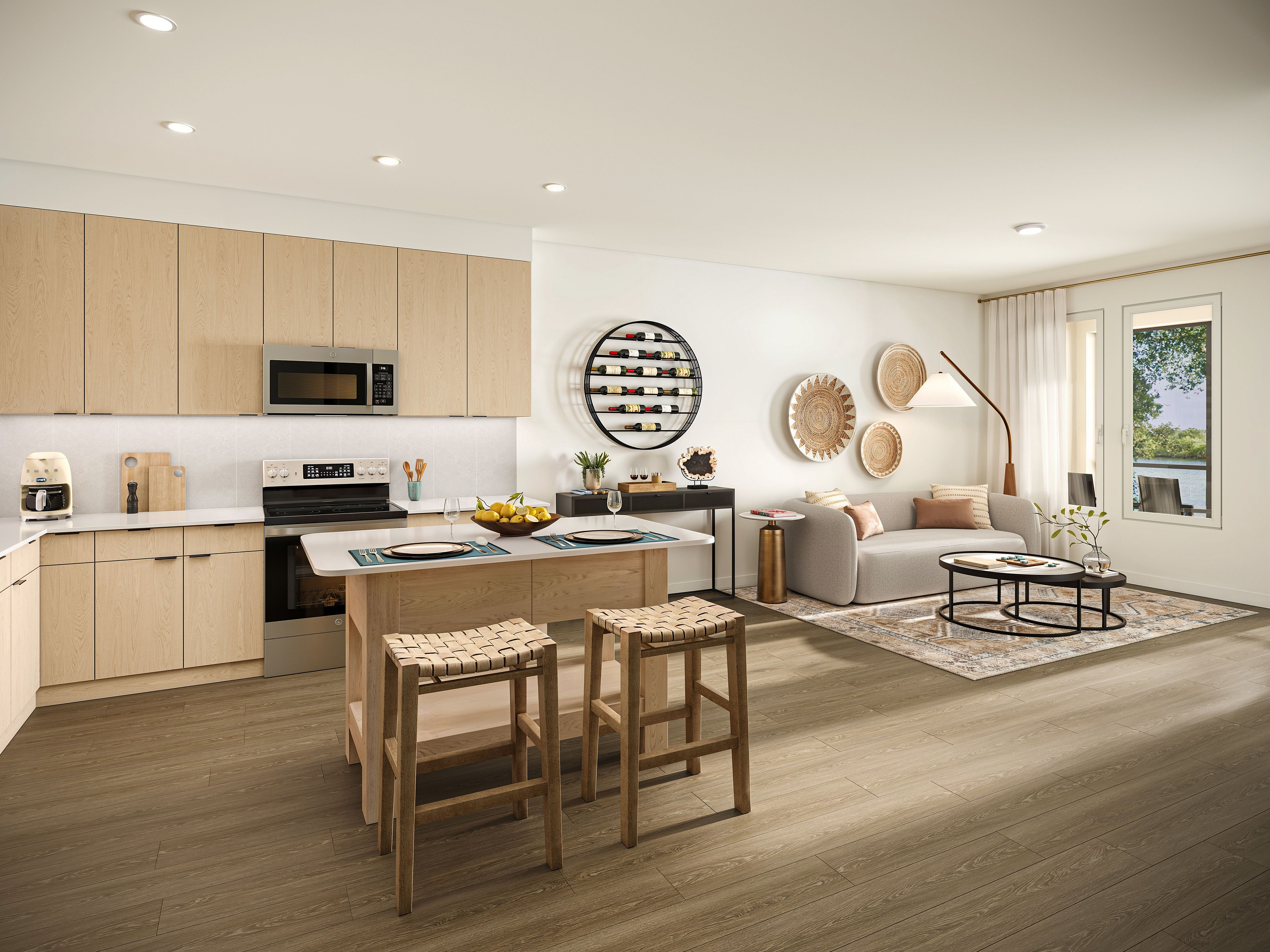 Modern open-concept kitchen and living room featuring light wood cabinetry, elegant seating area, and large window with a serene view.