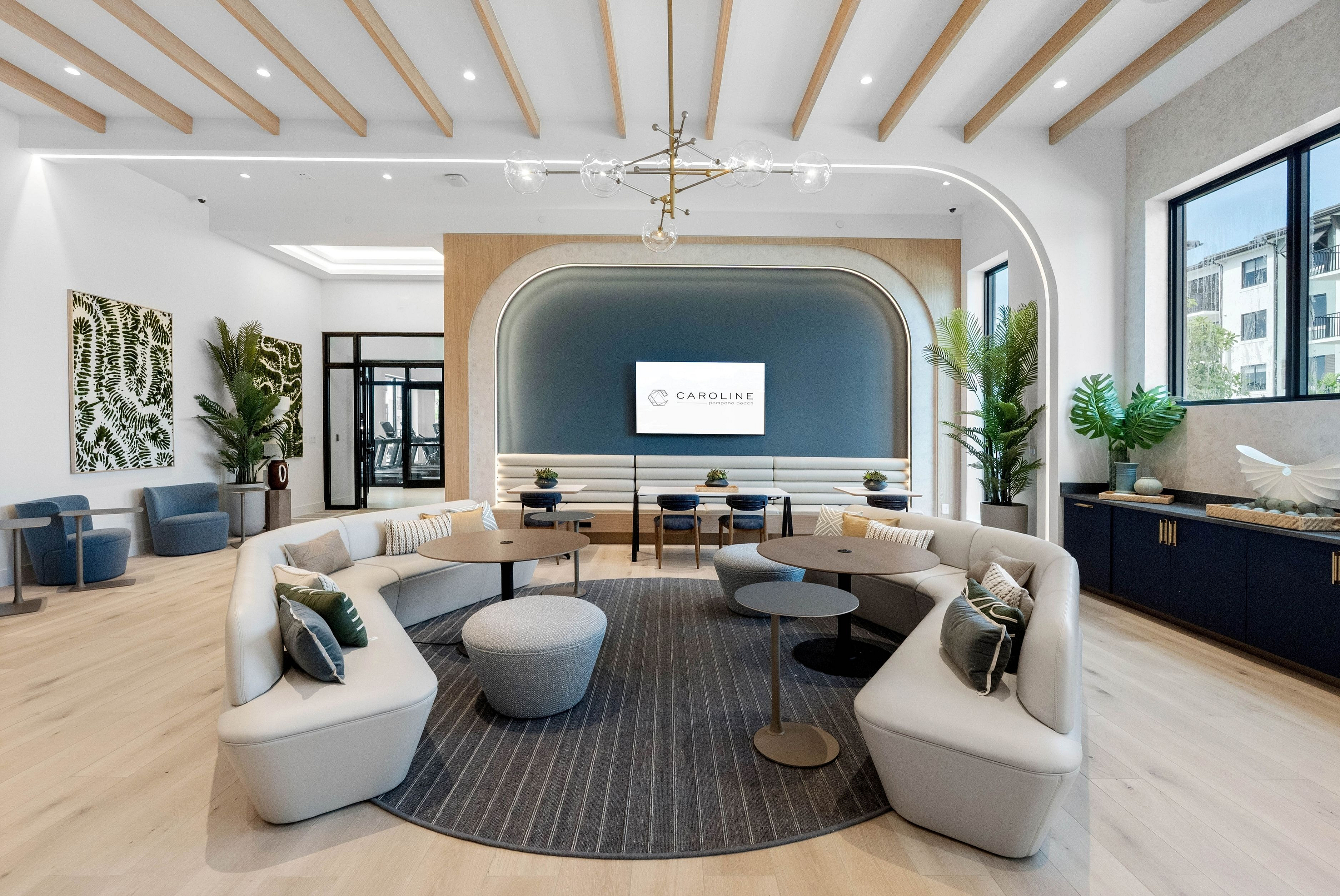 Elegant and modern lounge area with sleek furniture, stylish decor, and abundant natural light, offering a luxurious and inviting atmosphere.