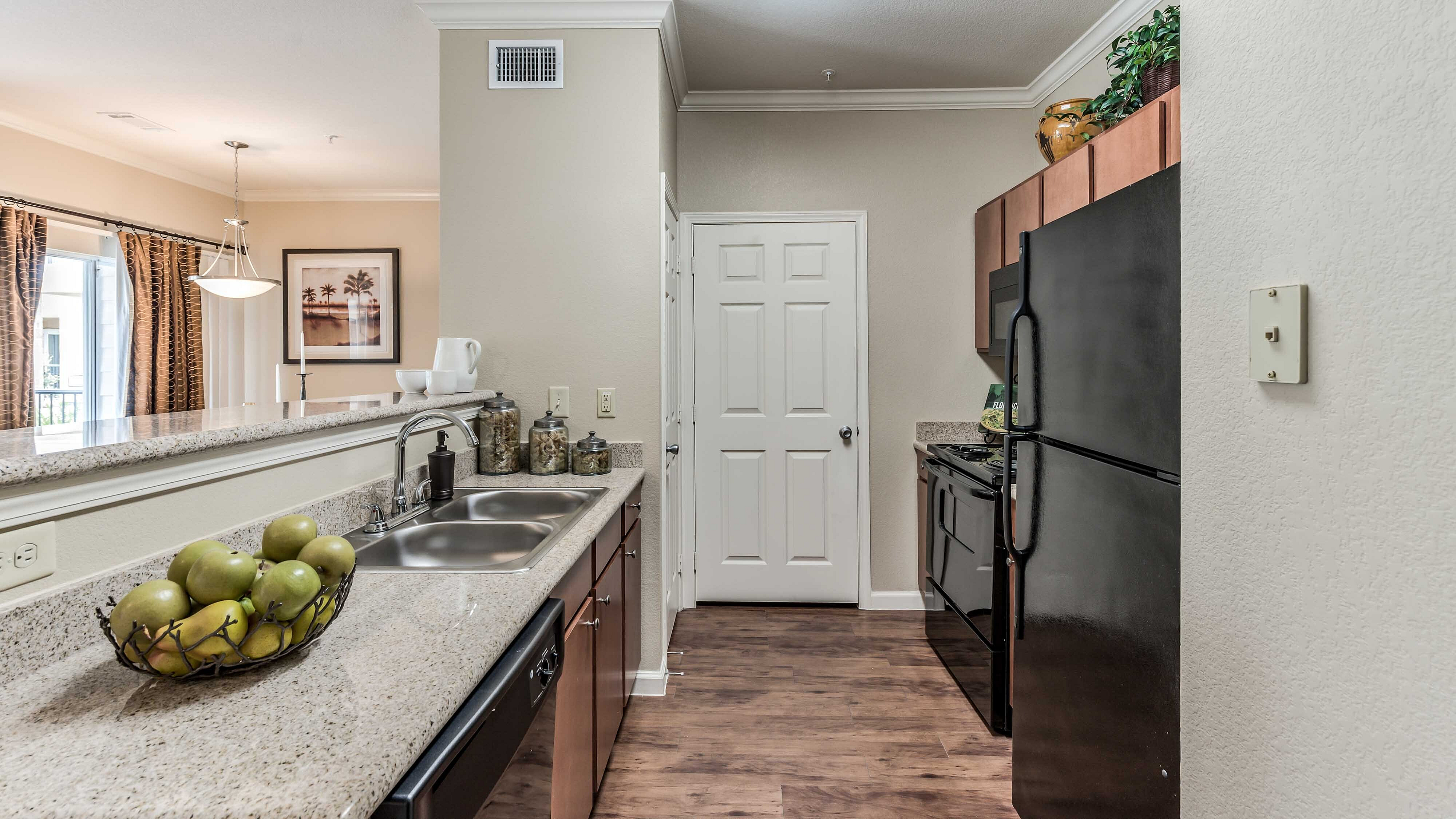 Modern apartment kitchen with granite countertops at Bennett Baytown