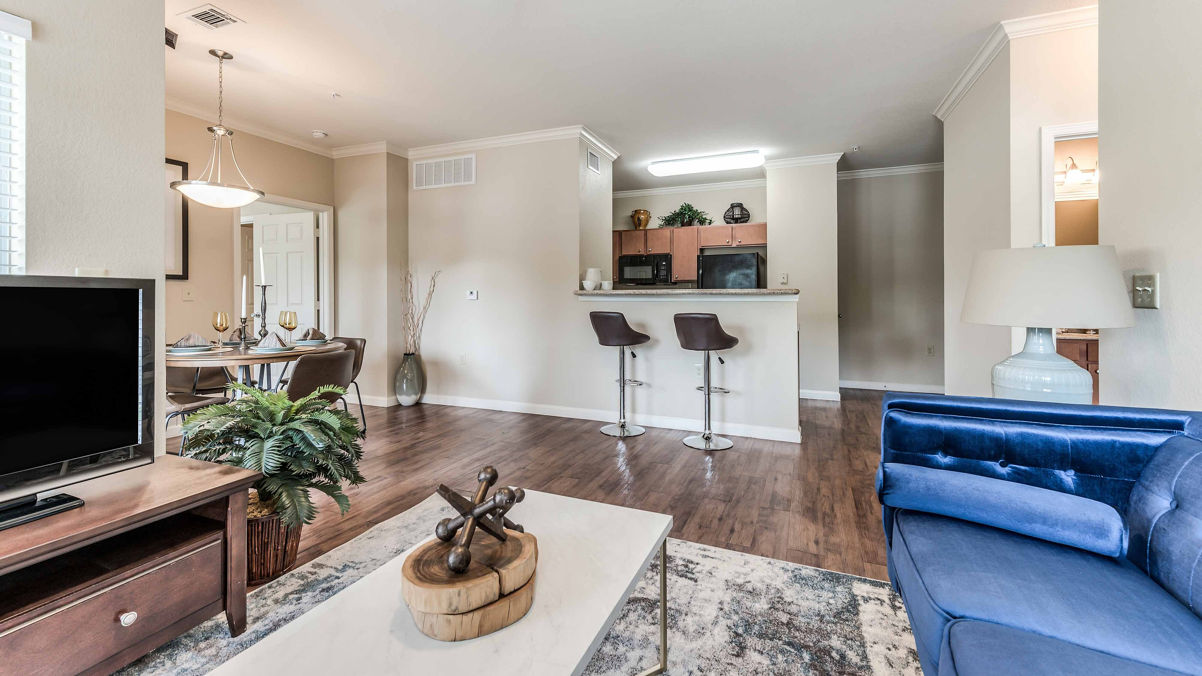 Apartment living room with open kitchen and dining area at Bennett Baytown