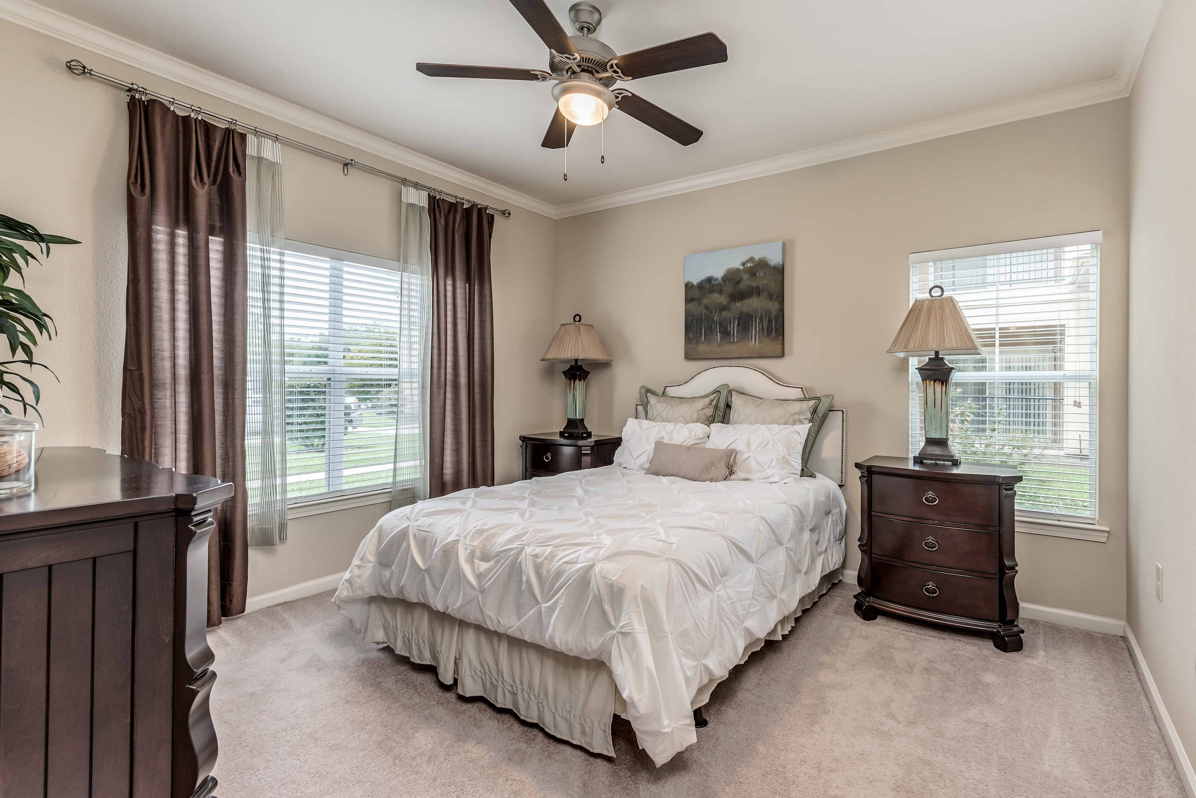 Apartment bedroom with large windows at Bennett Baytown