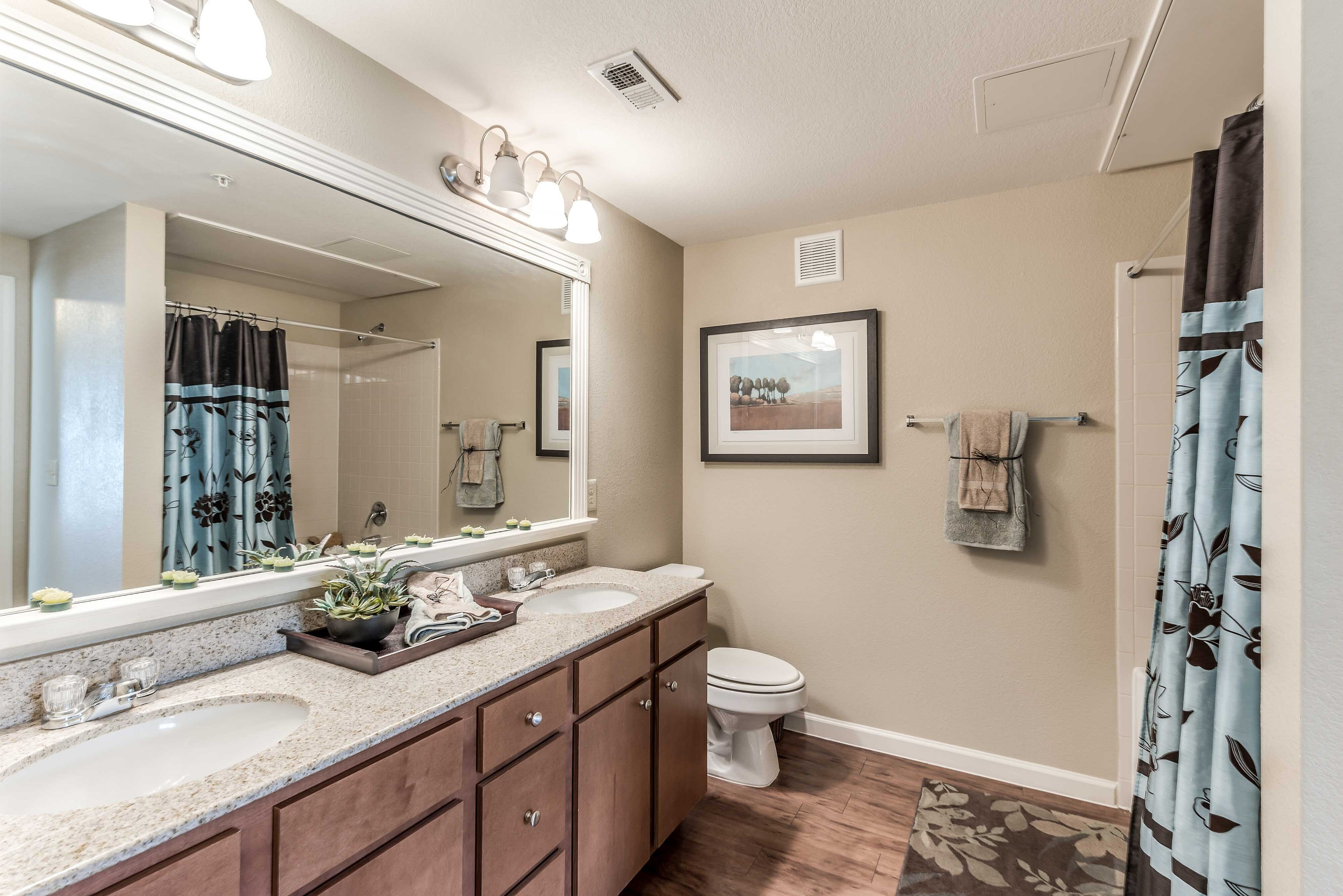 Apartment bathroom with large vanity and mirror at Bennett Baytown