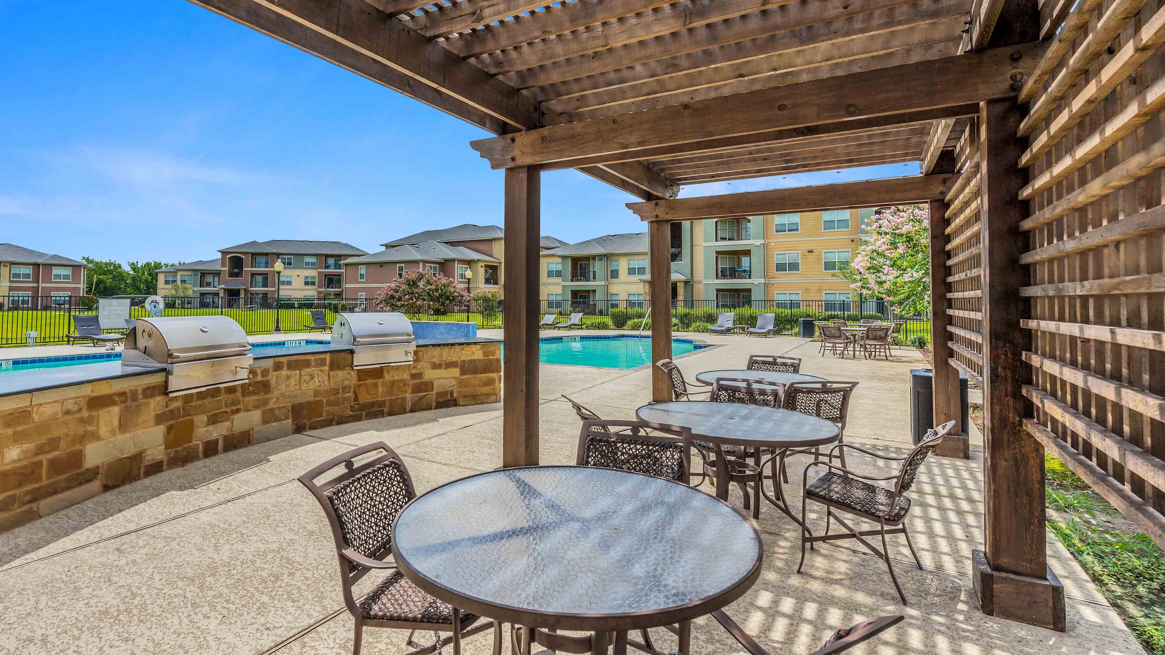 Covered outdoor patio overlooking the community swimming pool