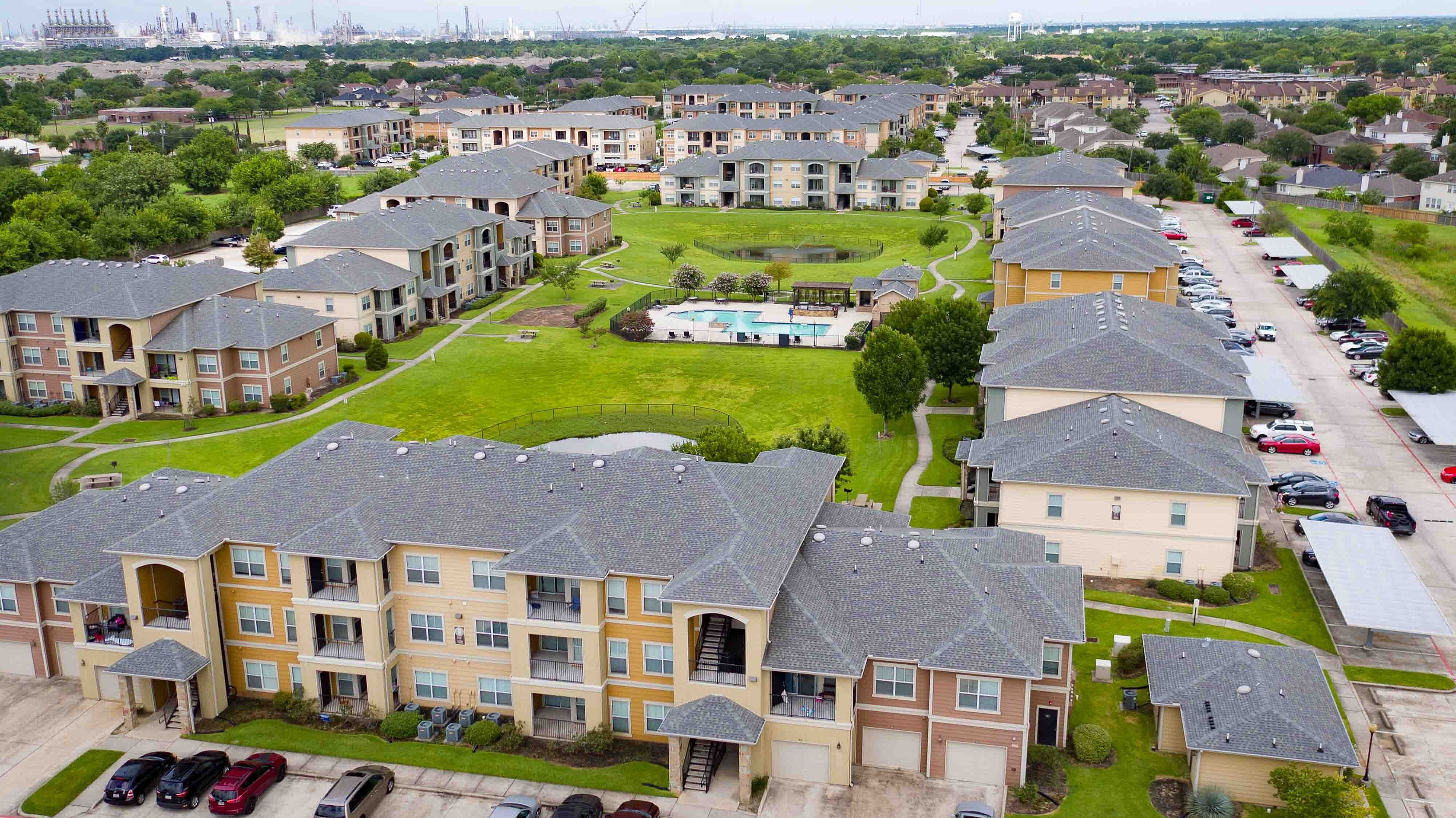 Aerial view of apartment clubhouse and surrounding residential buildings