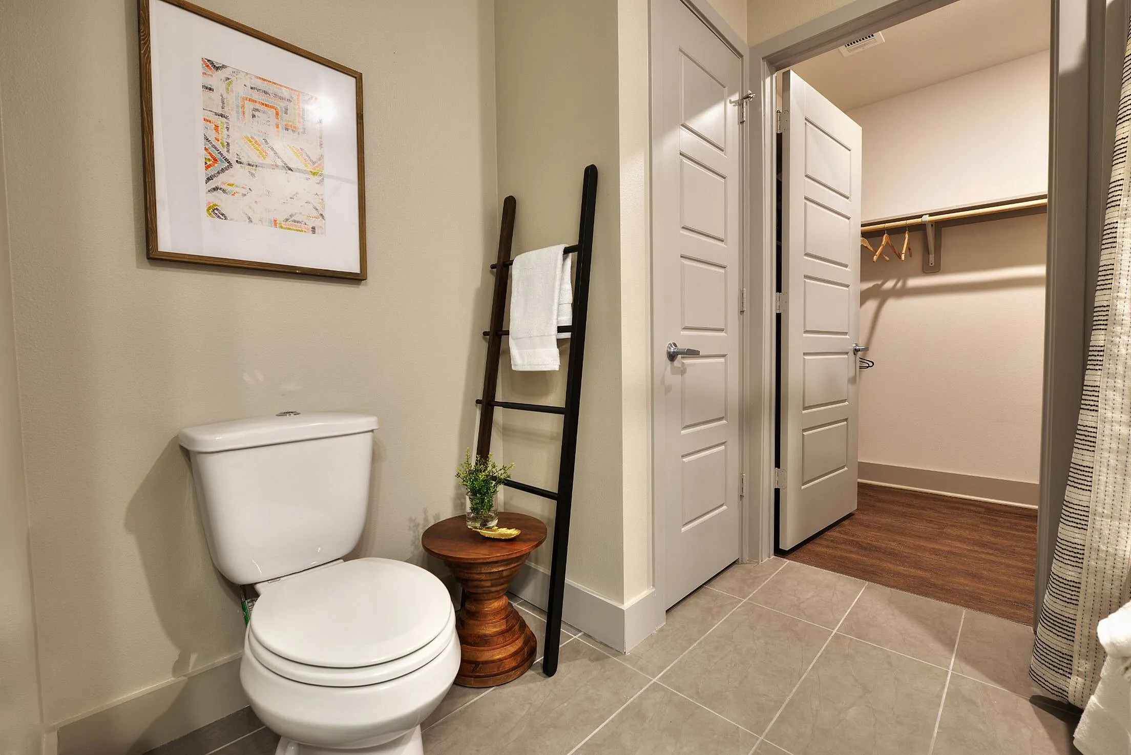 Bathroom with toilet, towel ladder and walk-in closet
