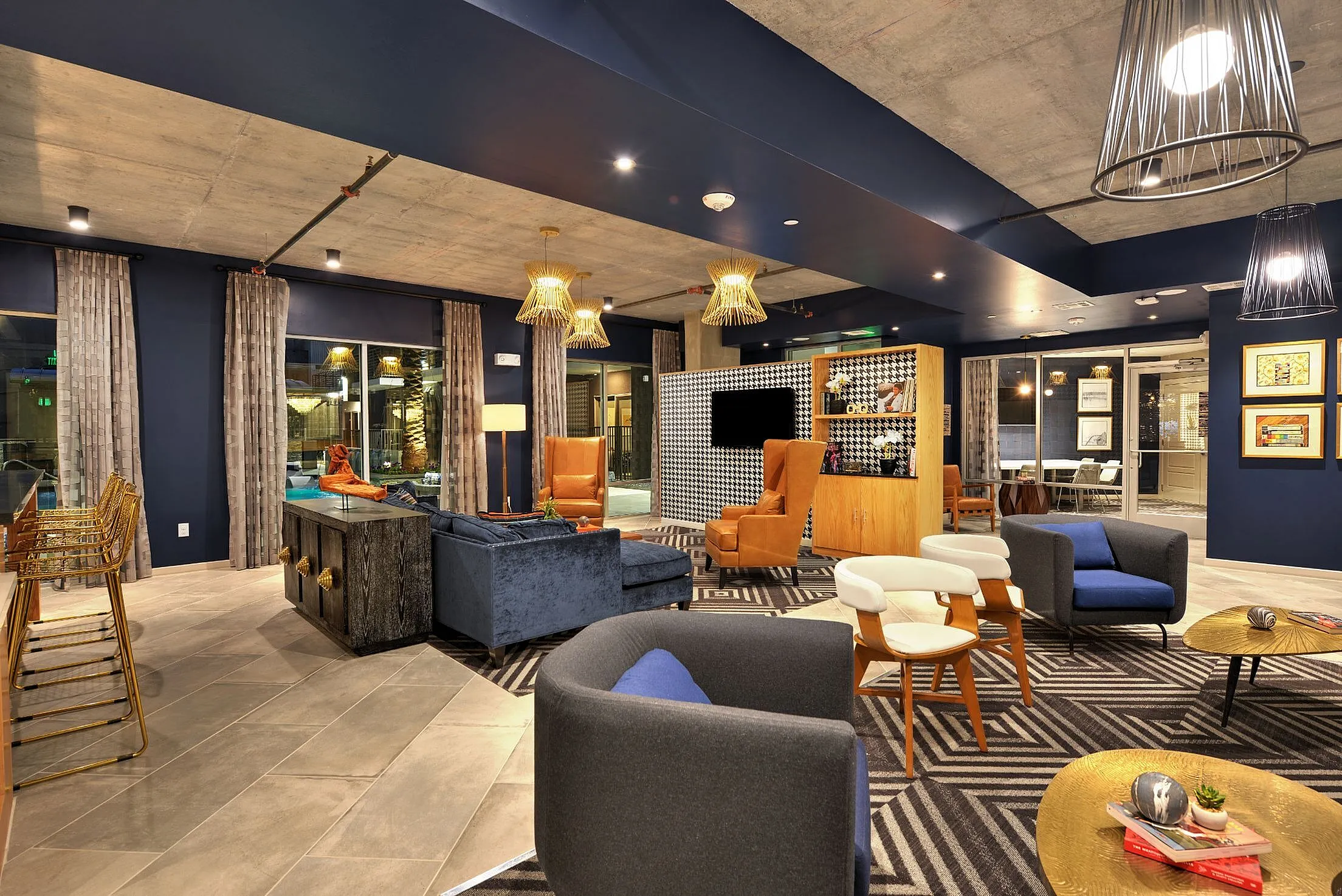 Clubhouse lounge with sofas, bar seating and pendant lights