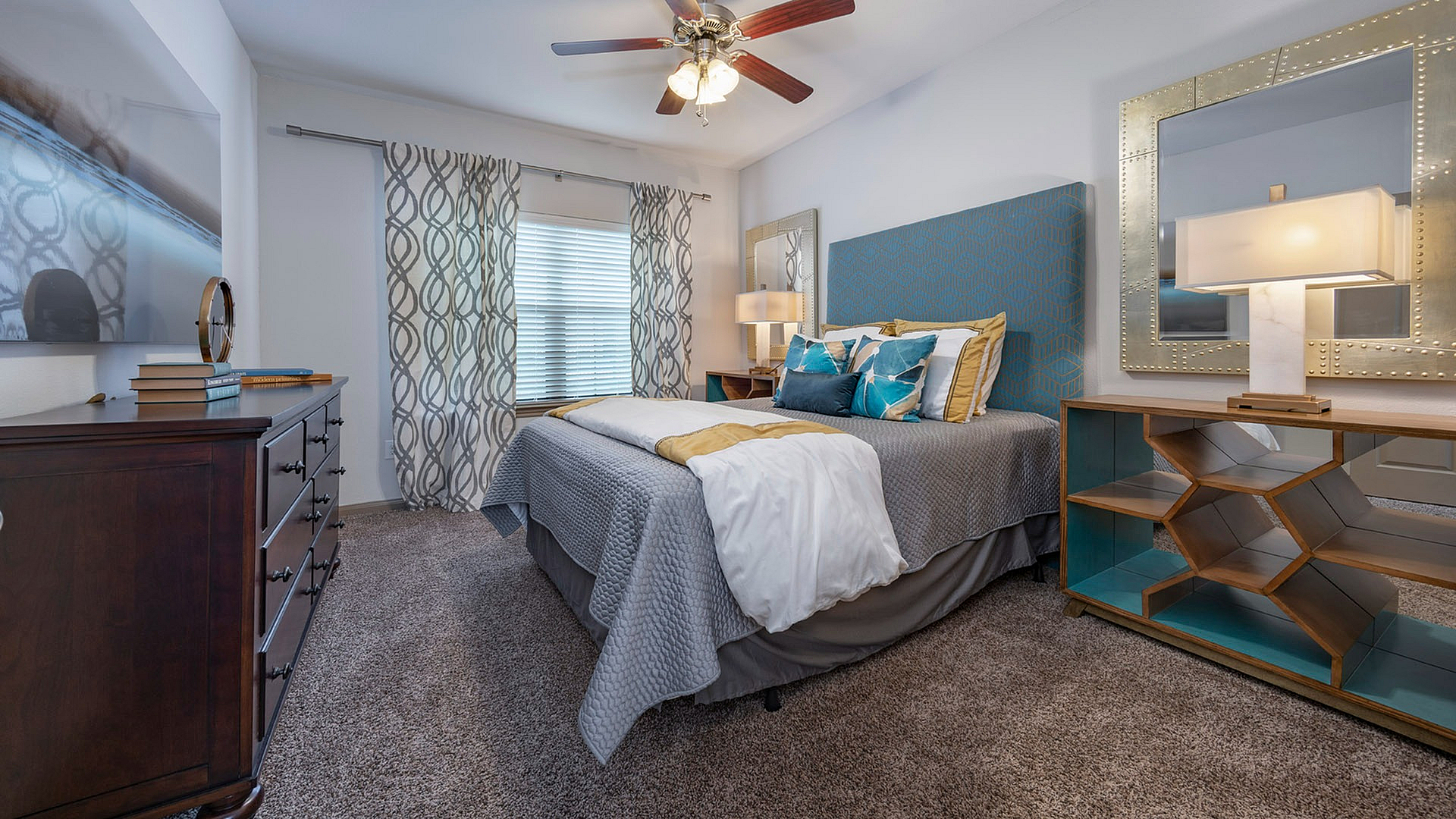 Elegant bedroom with plush carpeting, modern decor, and stylish lighting, offering a cozy and inviting atmosphere.