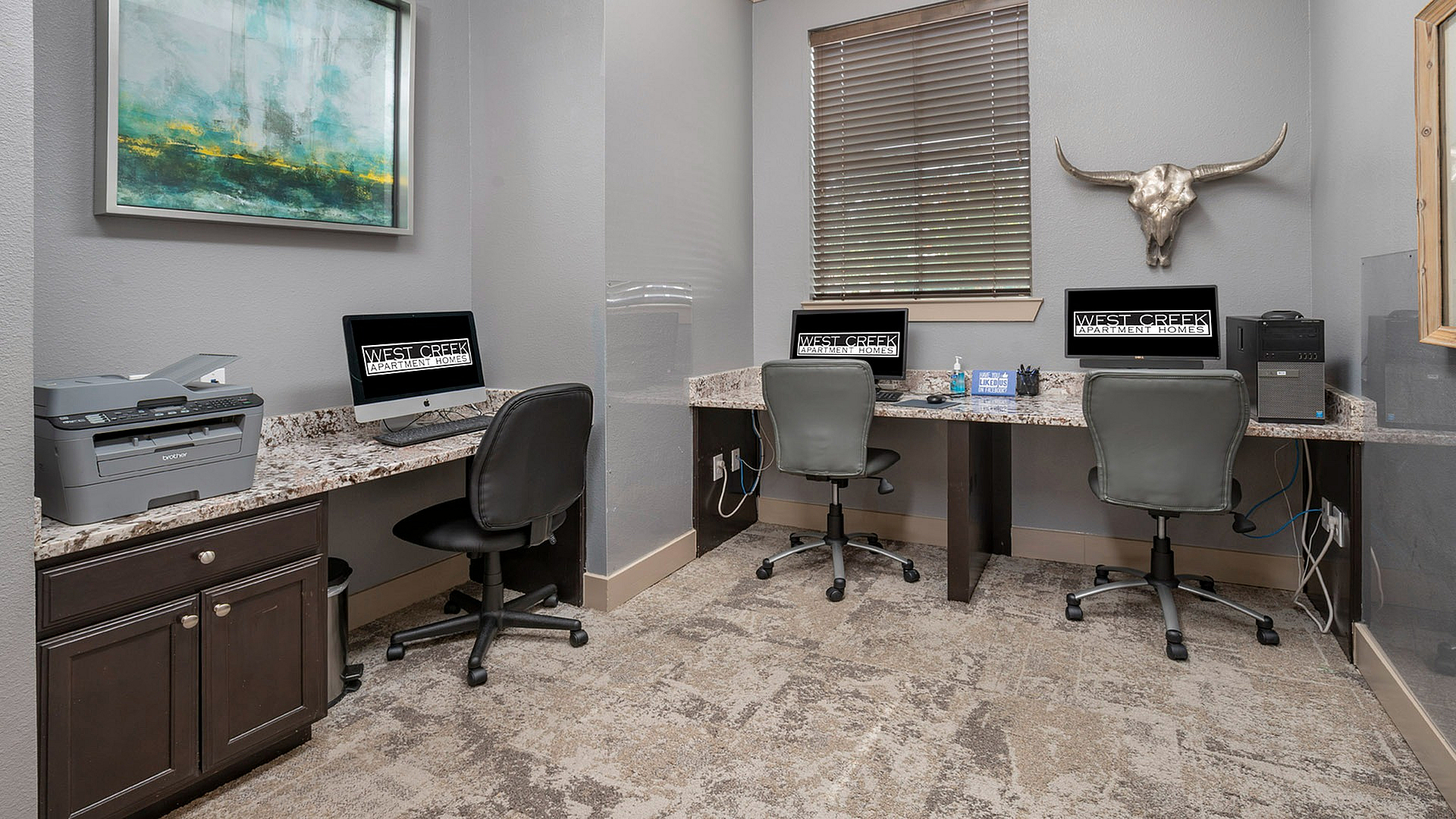 Modern apartment workspace featuring sleek granite countertops, computer stations, and stylish decor for productive living.