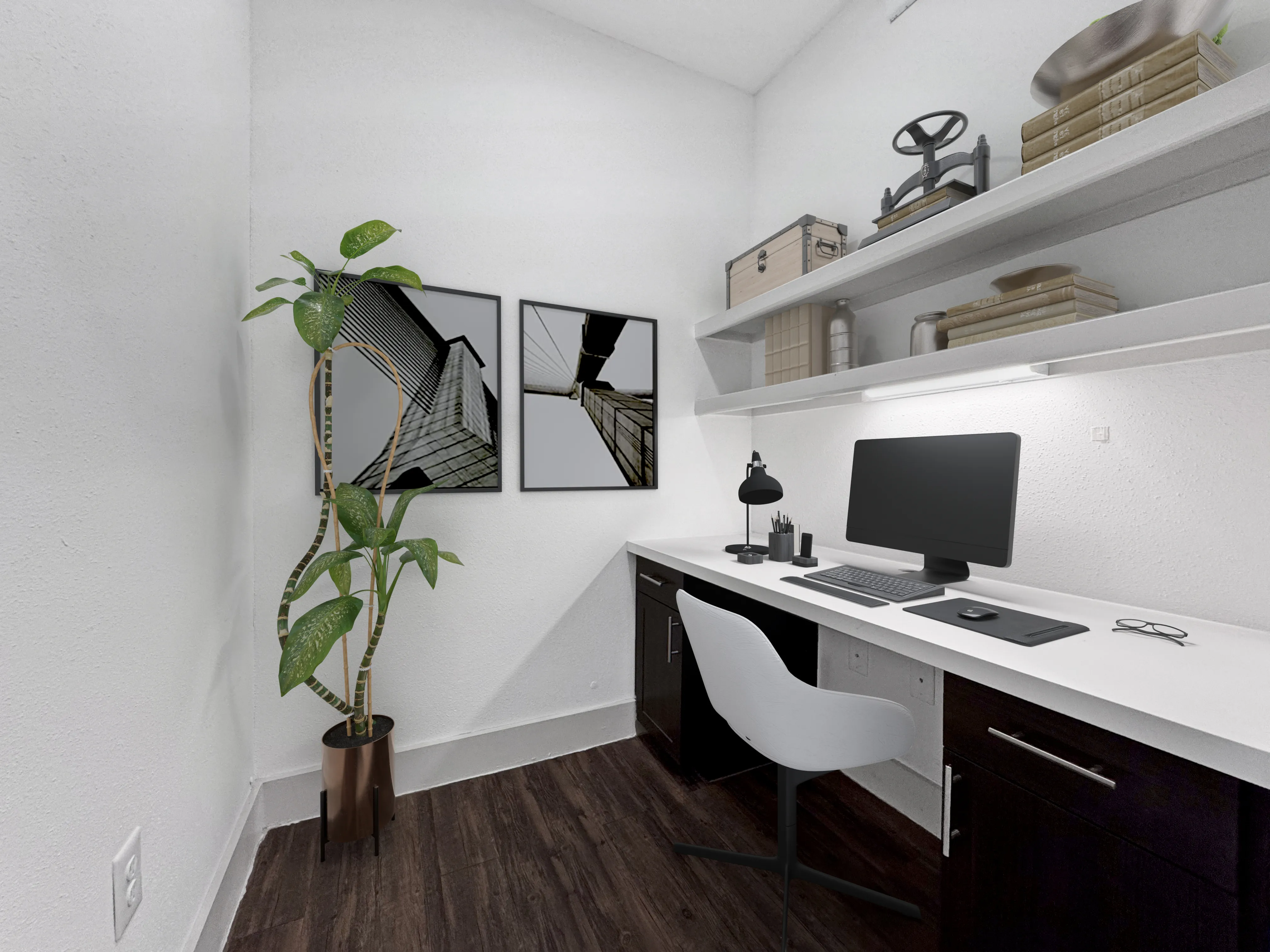 Modern home office setup with sleek white desk, computer, minimalist decor, and abstract artwork.