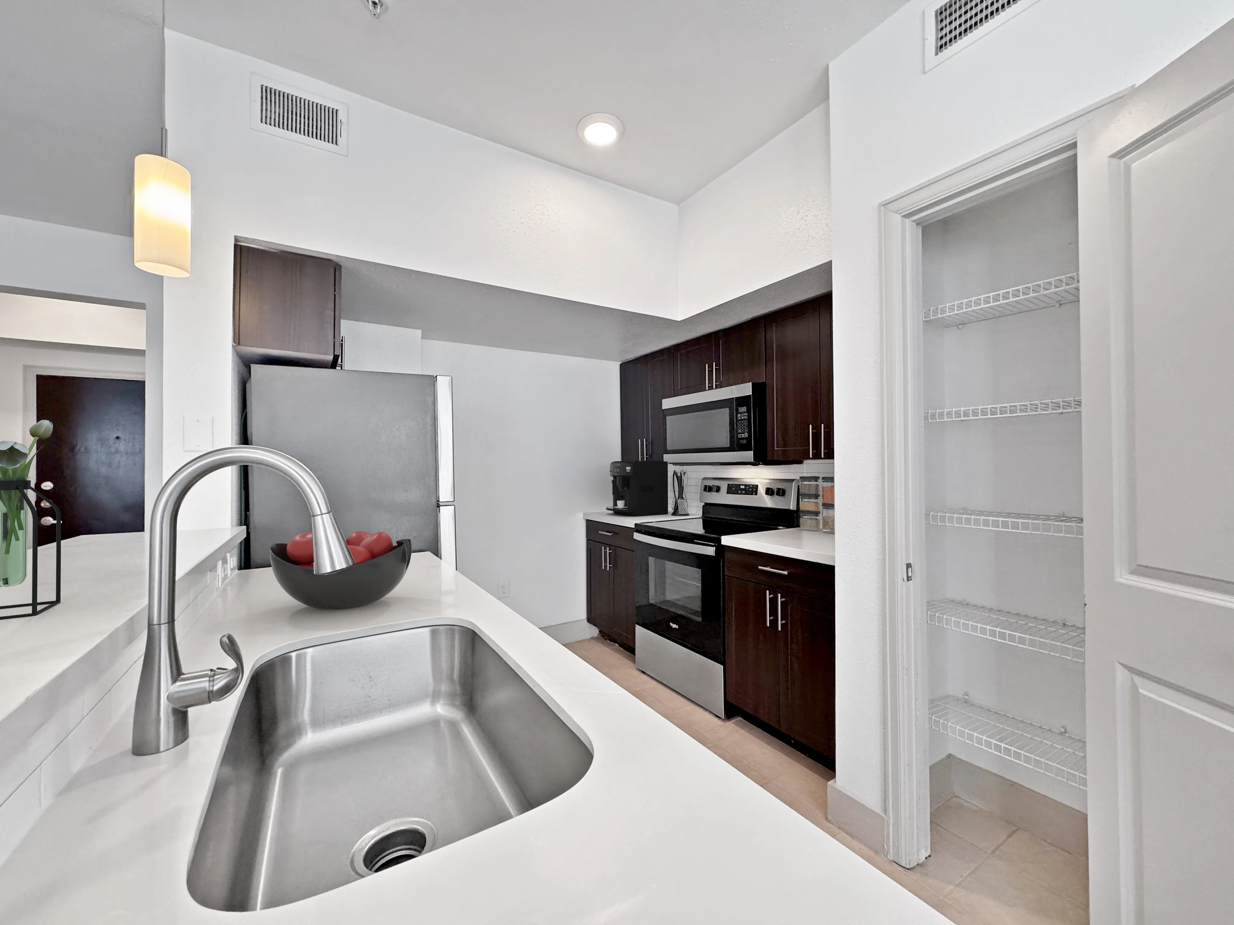 Modern kitchen with sleek stainless steel appliances and a spacious countertop.