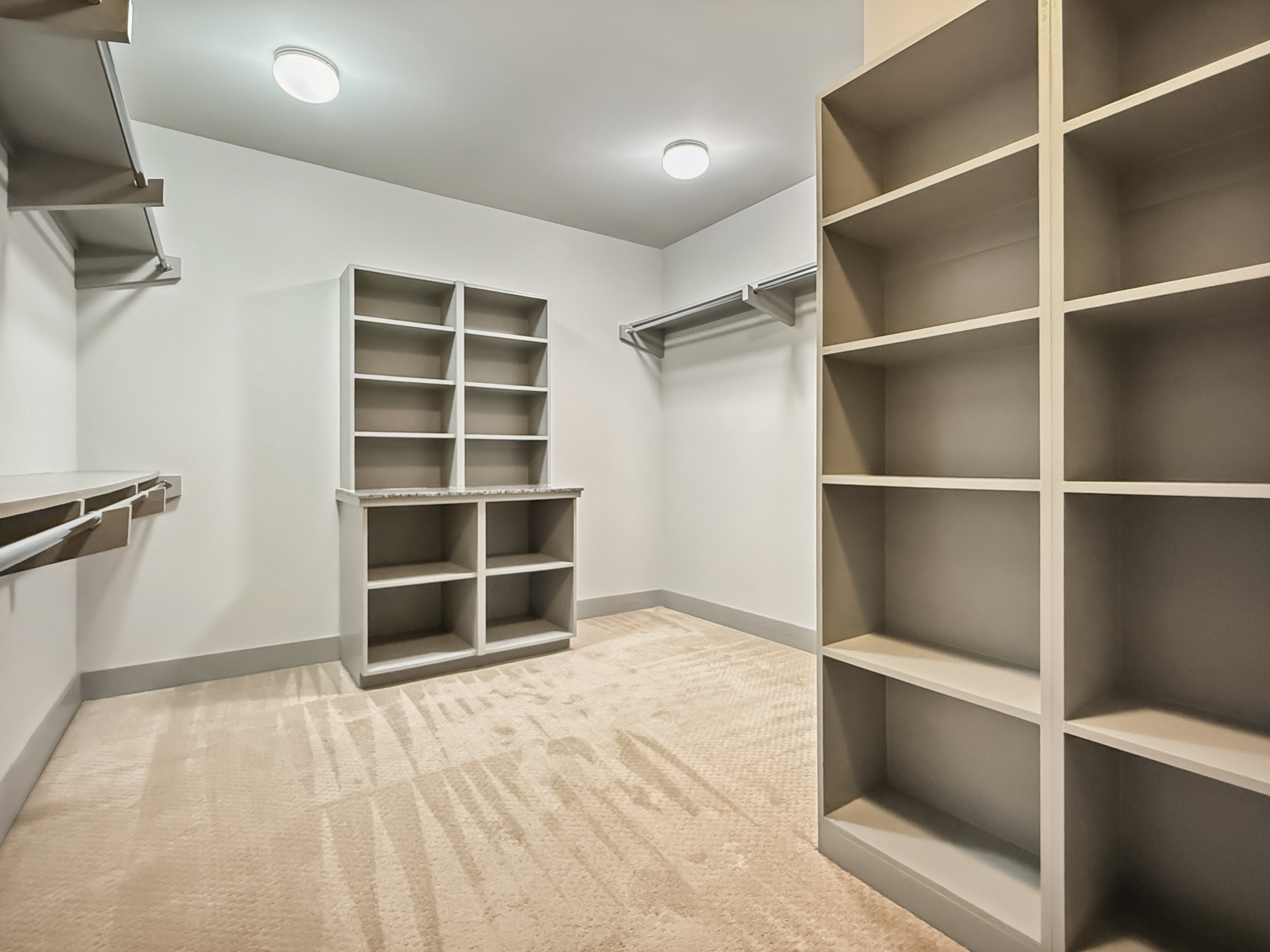Spacious walk-in closet with ample shelving and hanging space, perfect for organized living.