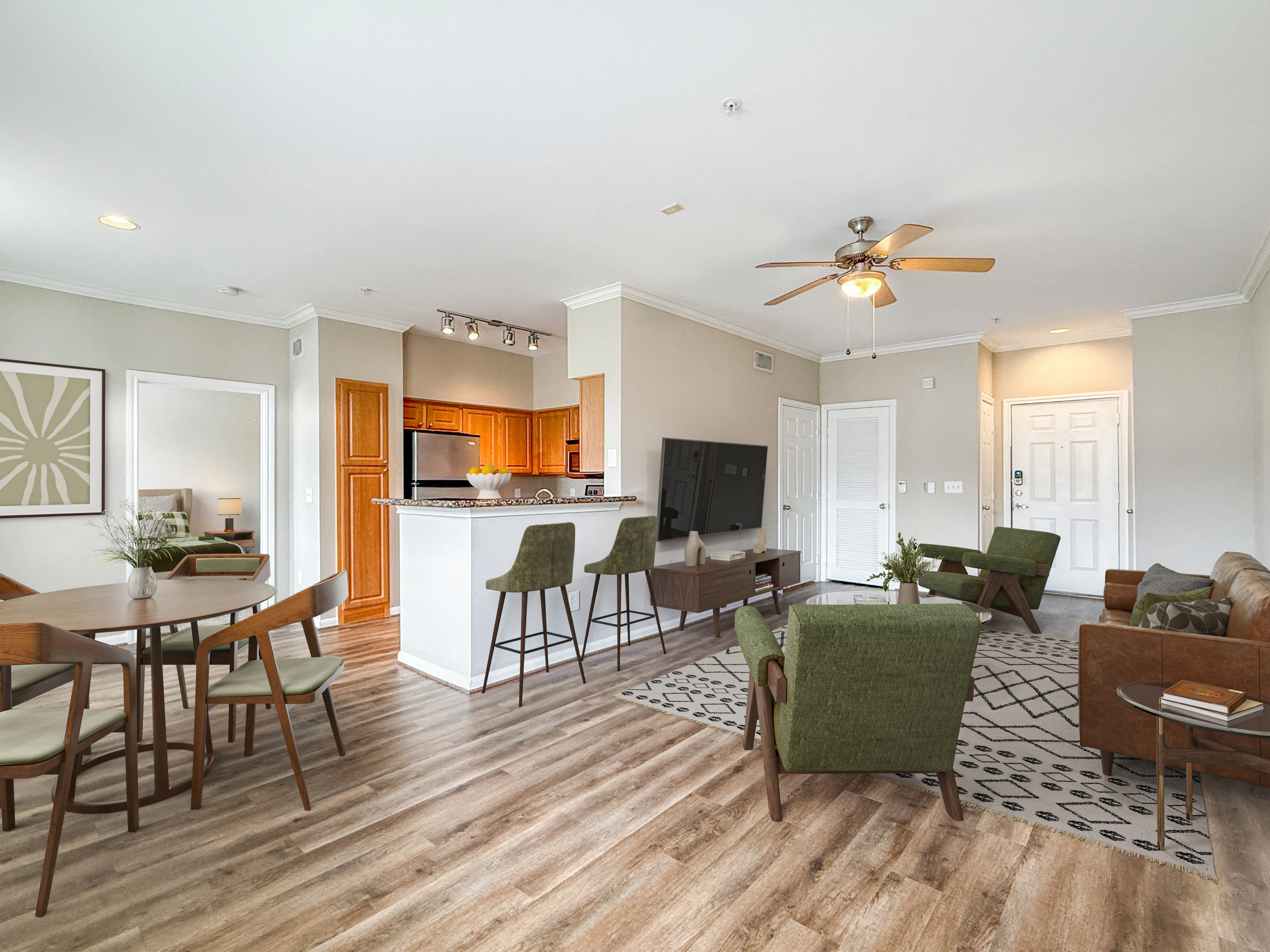 Bright and spacious open-concept living area featuring modern kitchen with bar seating, stylish dining space, and cozy lounge with plush seating.
