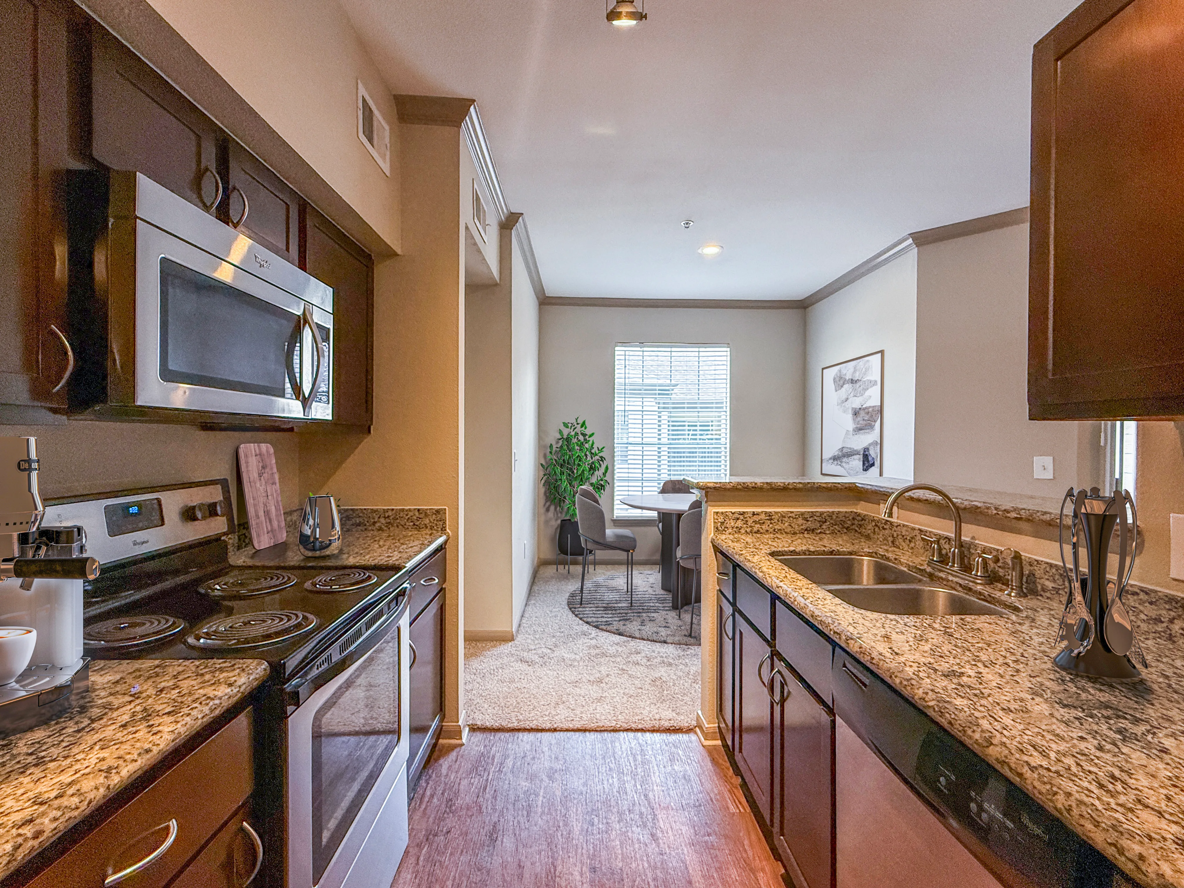 Modern kitchen with granite countertops, stainless steel appliances, and a cozy dining area with natural light flowing in.