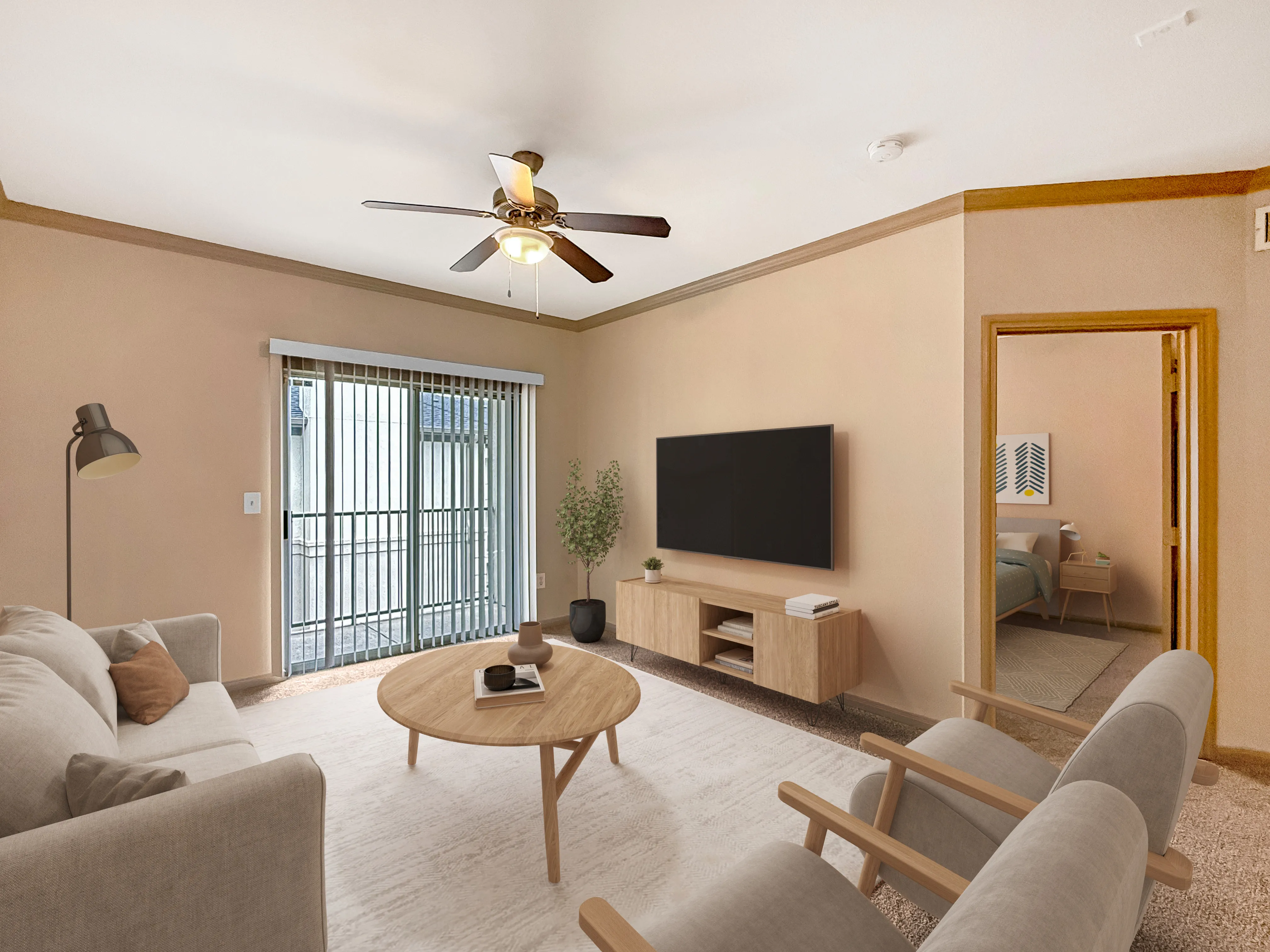 Cozy living room with modern furniture, large window sliding doors, ceiling fan, and neutral tones for a welcoming atmosphere.
