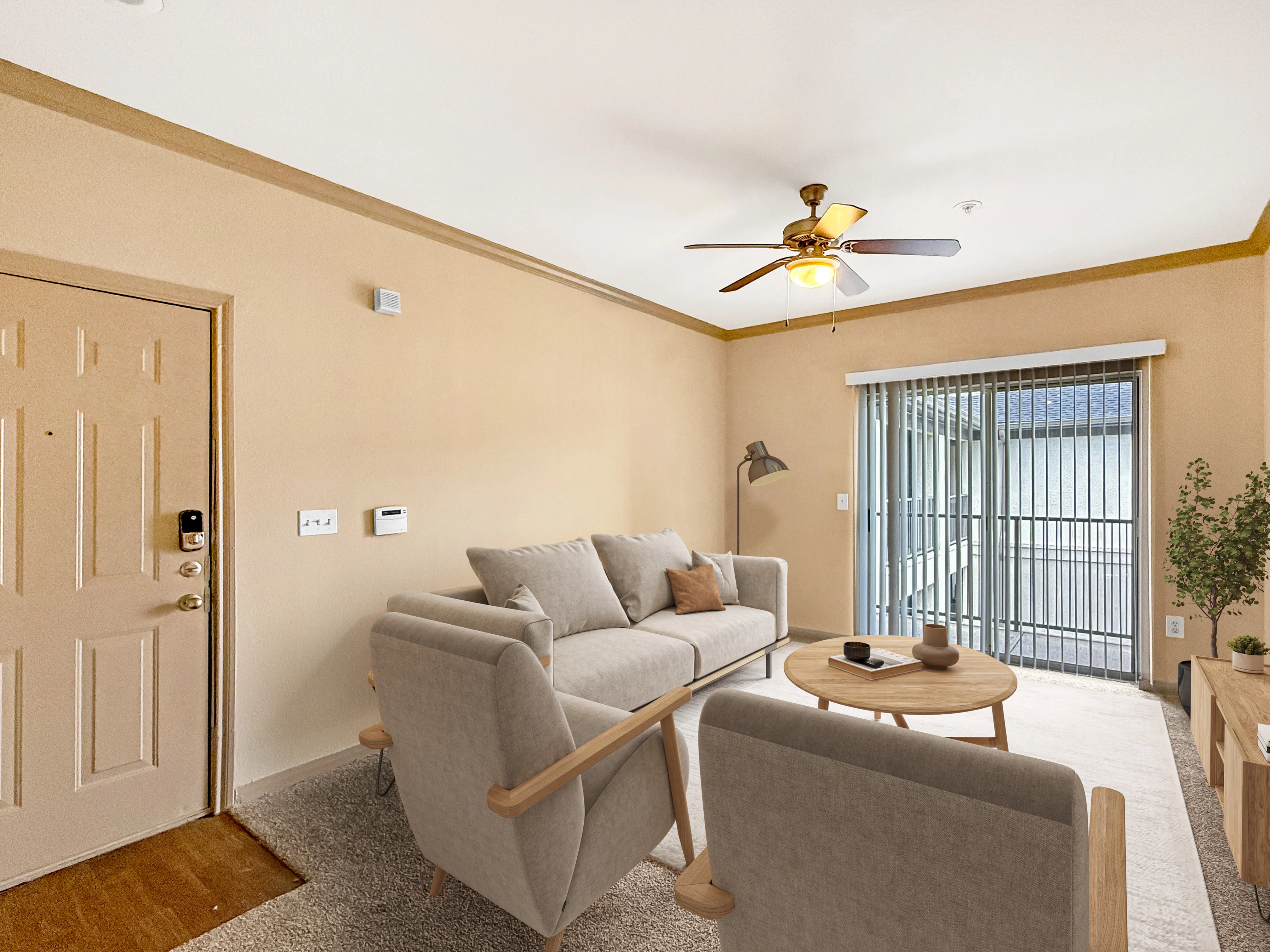 Inviting living room with cozy seating, ceiling fan, and natural light from sliding glass doors.