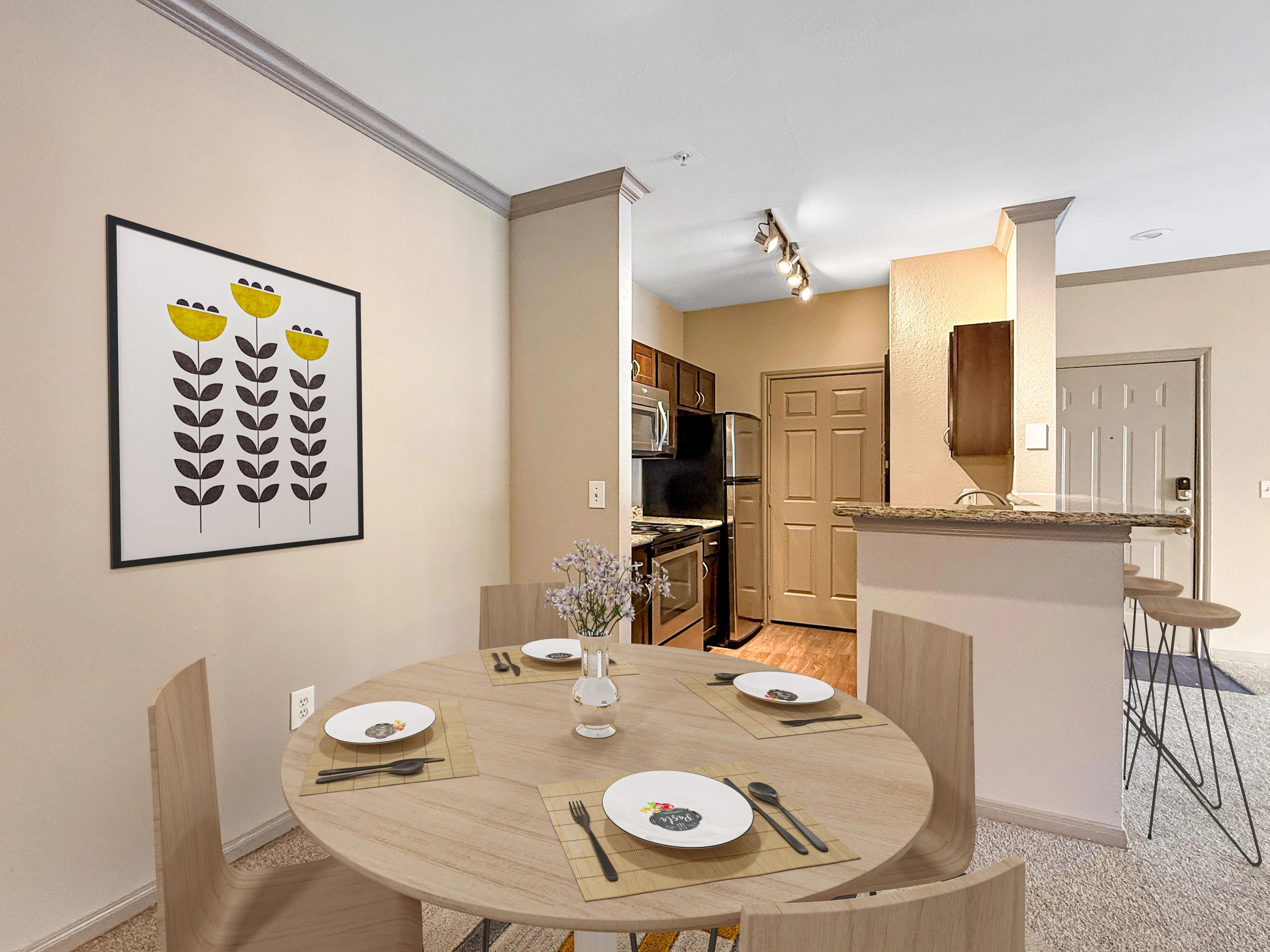 Modern dining area with sleek wooden table set for four, adjacent to a stylish open kitchen featuring granite countertops and contemporary appliances.