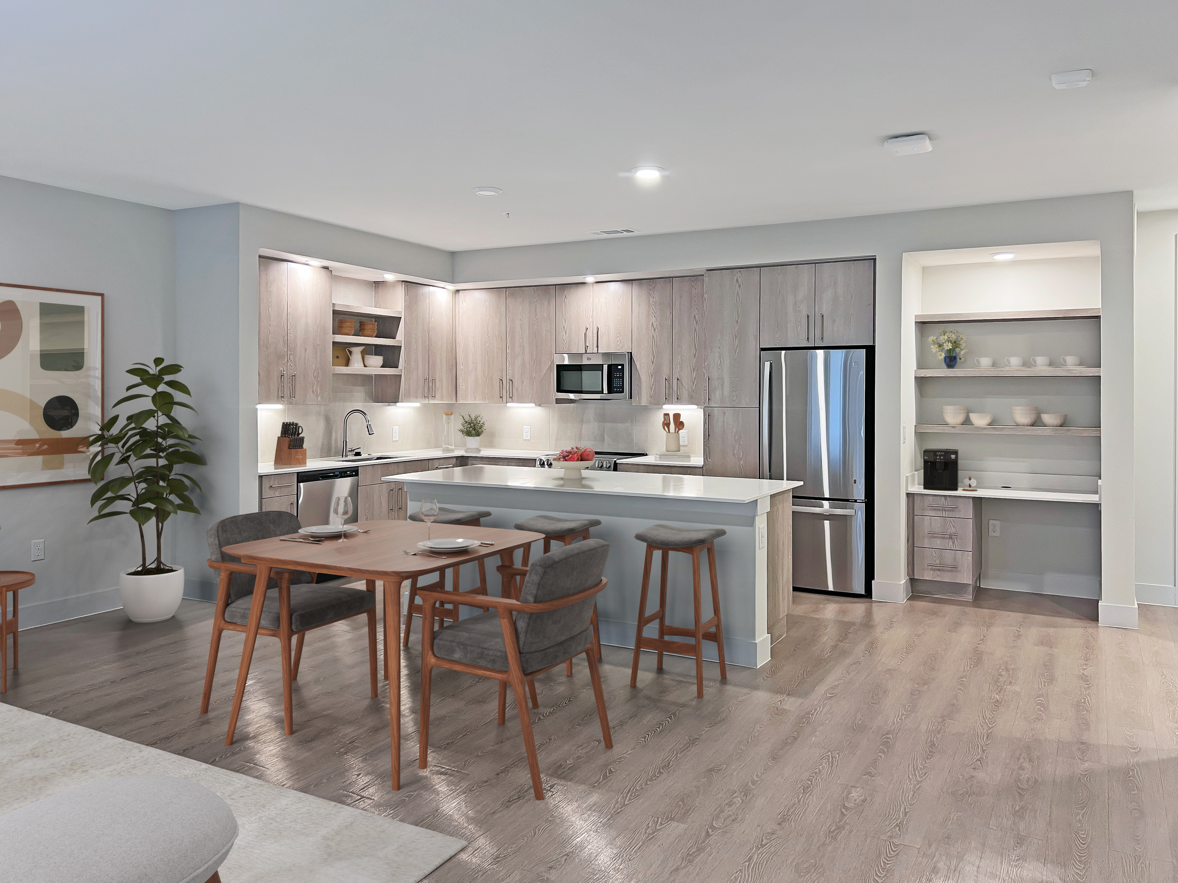 Modern open-plan kitchen and dining area with sleek cabinetry, stainless steel appliances, and elegant wooden dining set.