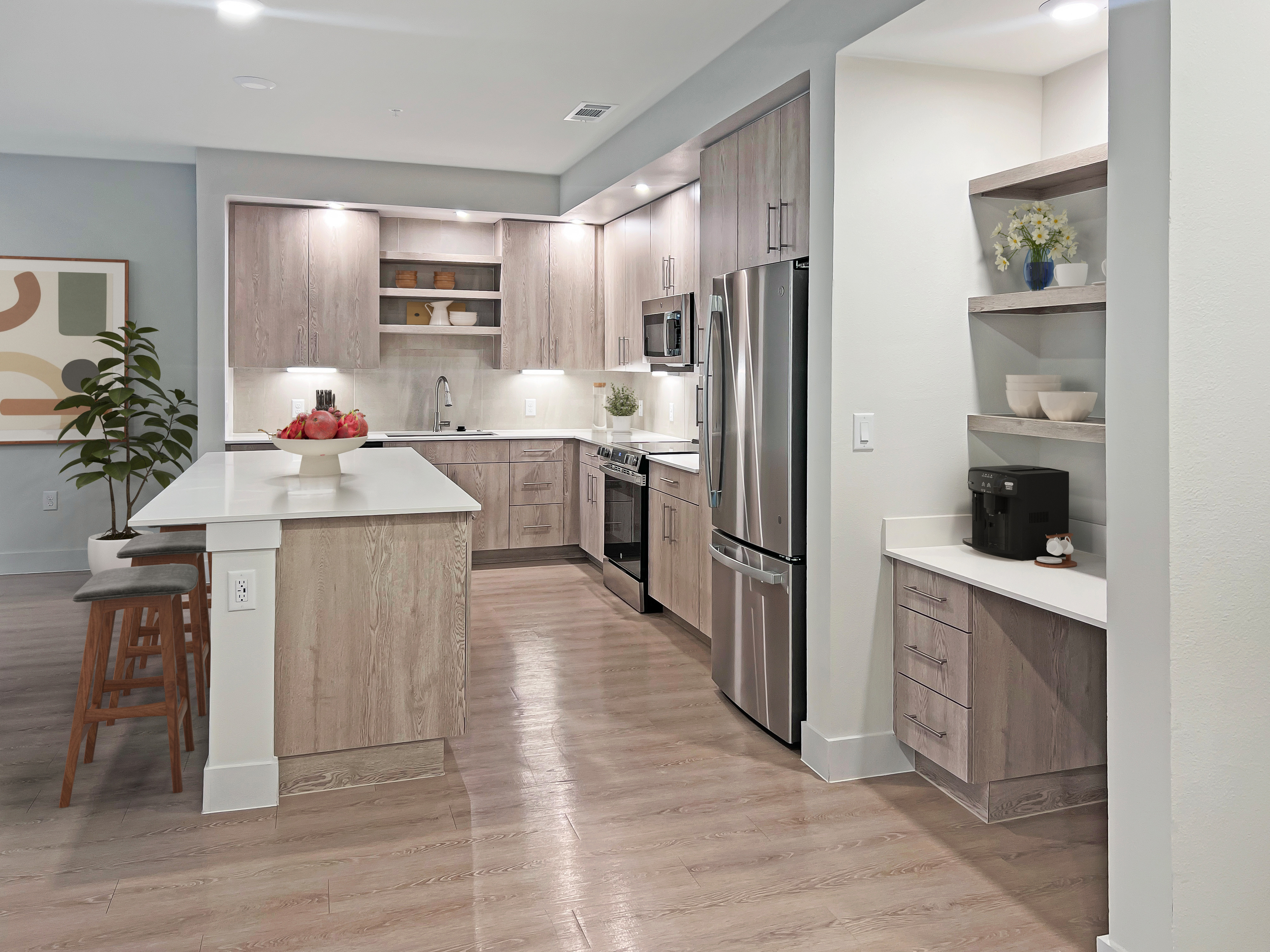 Modern kitchen with sleek wood cabinetry, stainless steel appliances, and a spacious island with stylish seating.