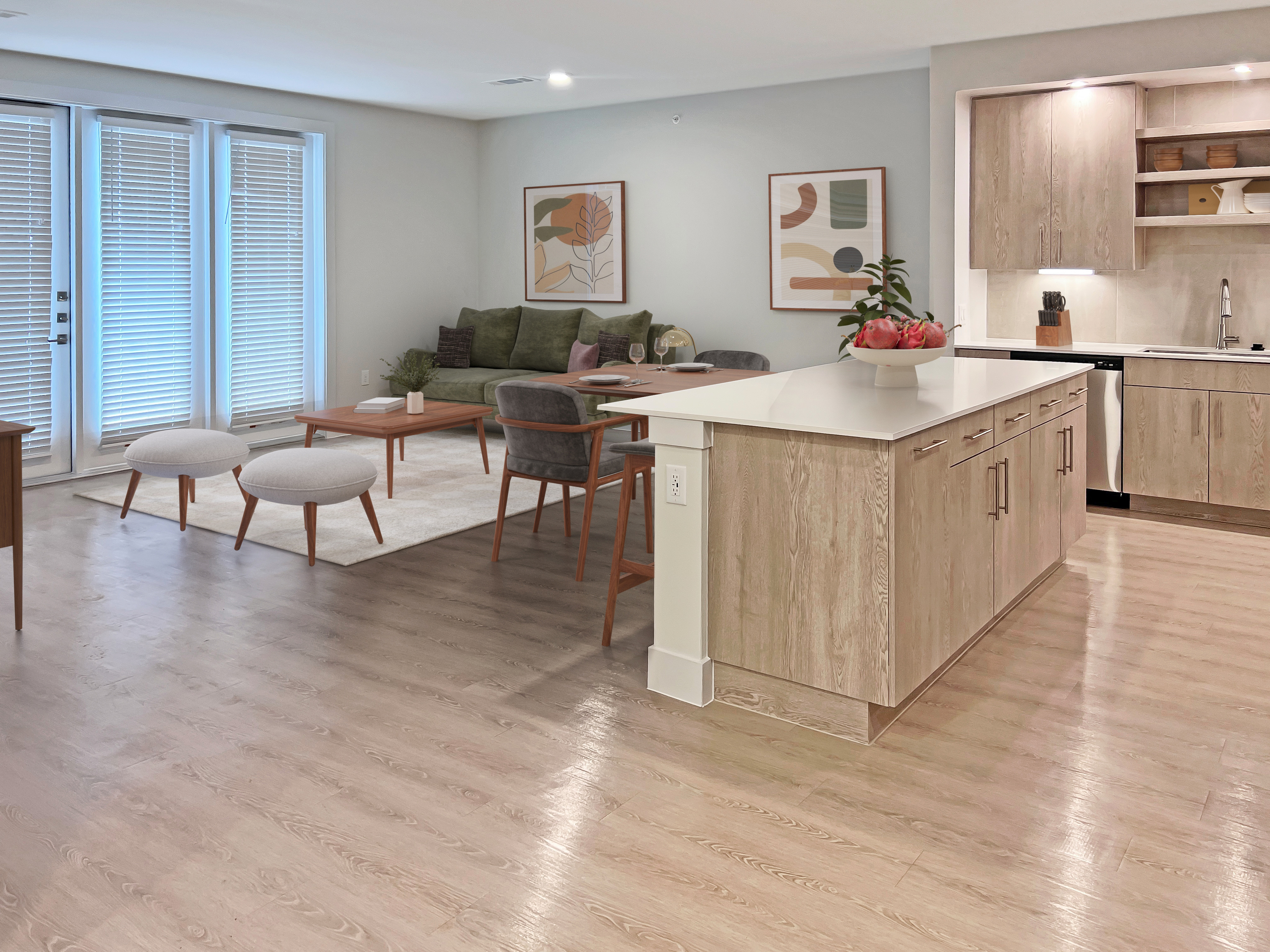 Modern open-concept living space with stylish kitchen island, cozy seating area, and abundant natural light from large windows.