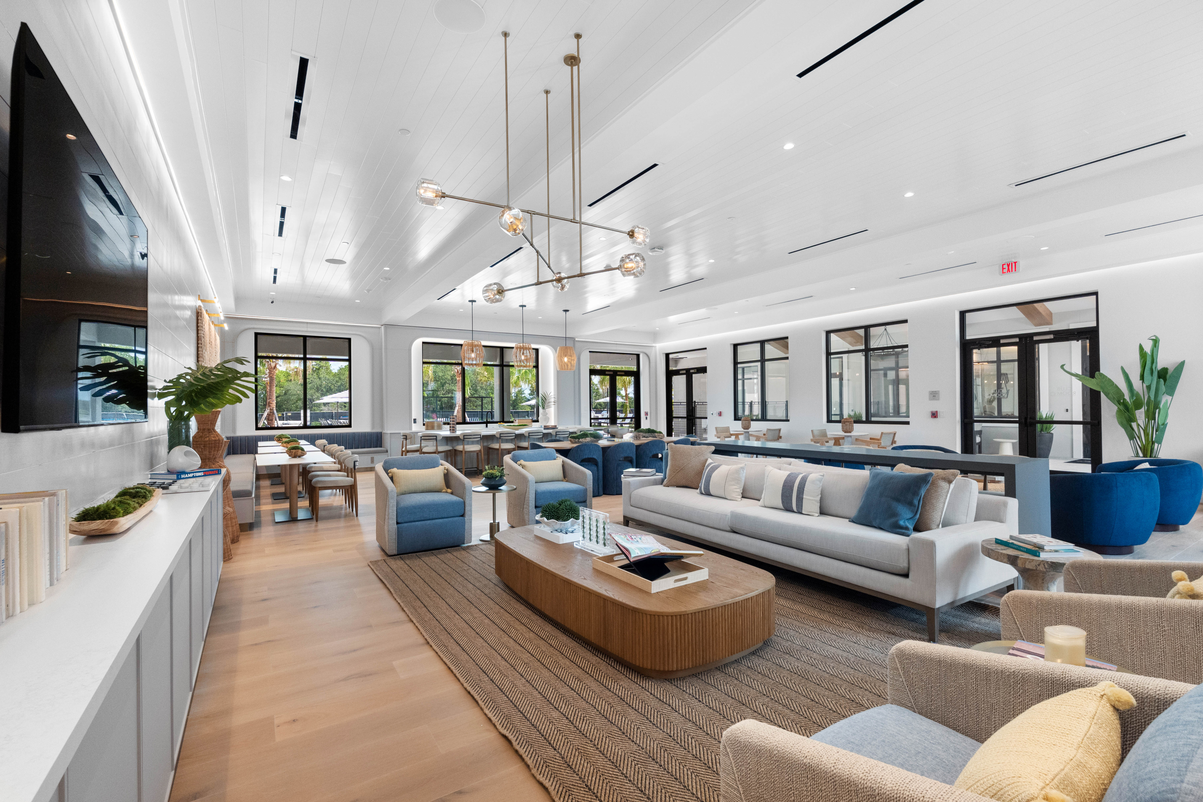 Contemporary open-plan lounge with plush seating, stylish lighting, and modern decor, offering an inviting atmosphere for relaxation.