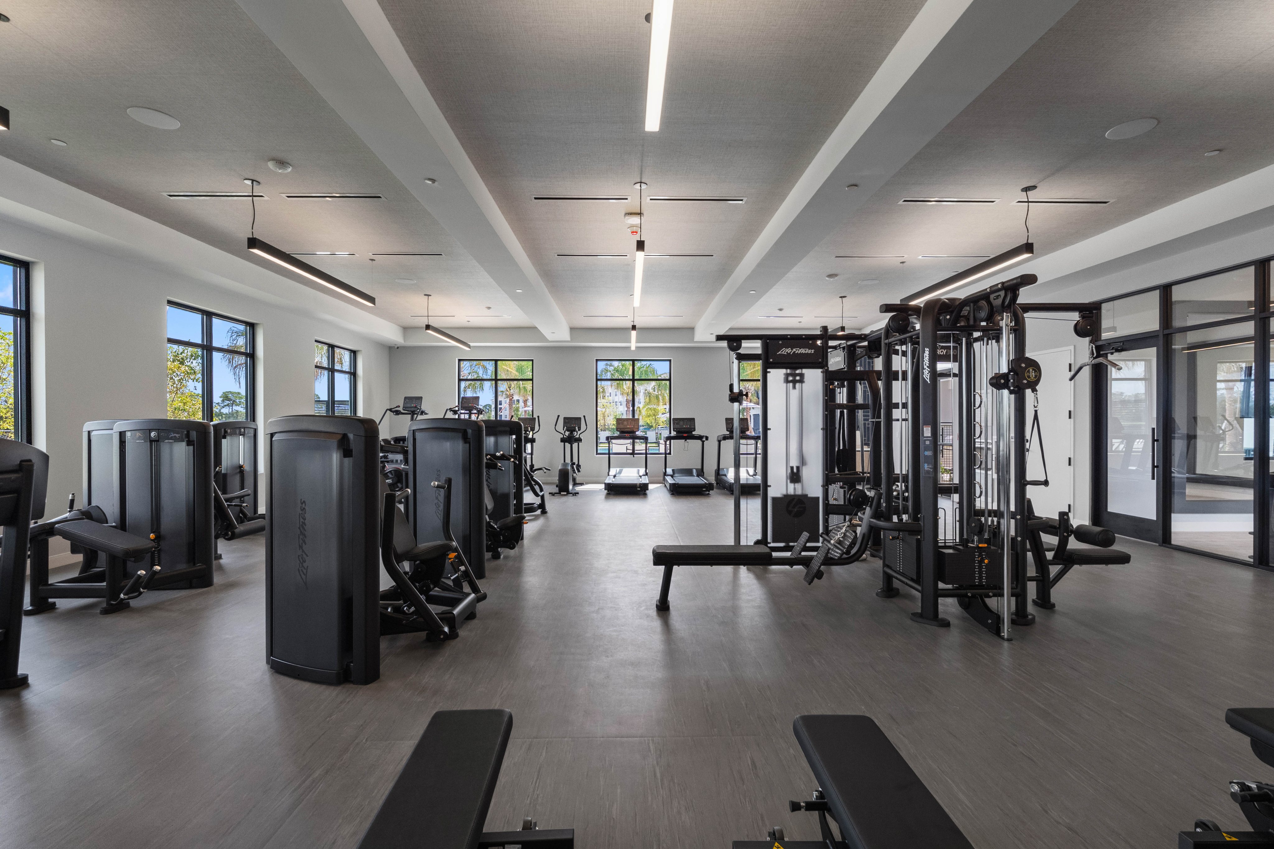 Modern fitness center with state-of-the-art exercise machines and abundant natural light.
