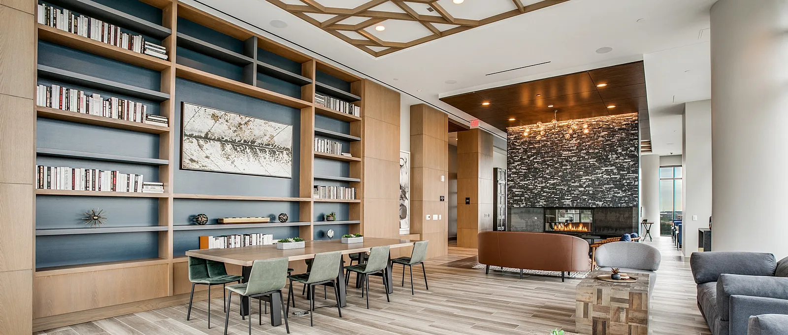 Elegant living area with modern fireplace, wooden flooring, and stylish bookshelves.