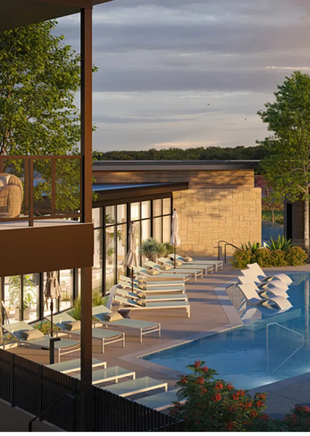 Luxurious apartment complex showcasing a serene outdoor pool area with modern lounge chairs, lush greenery, and a stunning sunset backdrop.