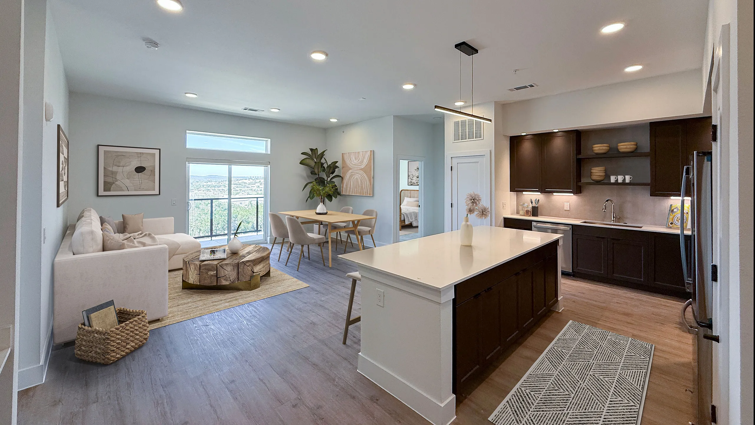 Modern apartment with open-concept living space featuring a bright living room, stylish dining area, and sleek kitchen with dark cabinetry.